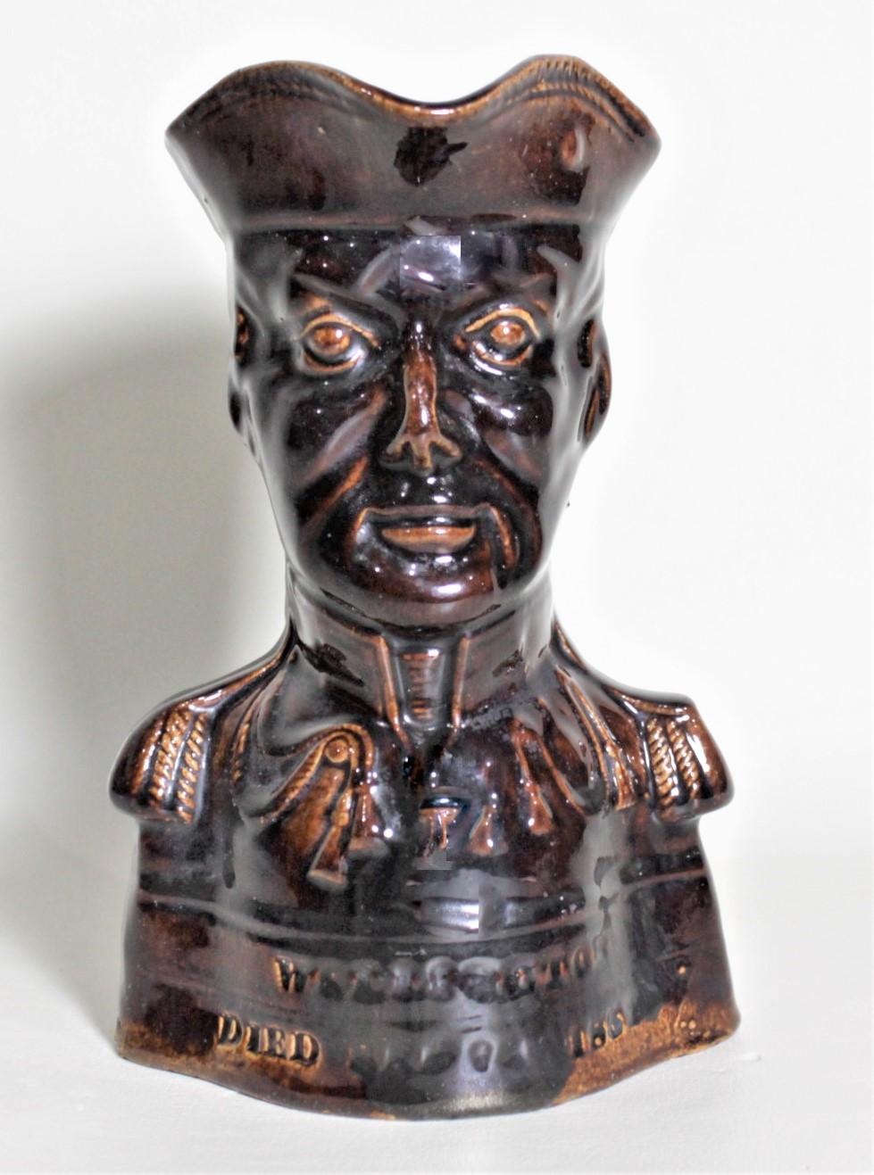 This antique character or toby jug is unmarked, but being attributed to the Rockingham Pottery Company of England and presumed to have been made in circa 1852. The jug commemorates the life of Lord Wellington and is done with a C. Treacle glazed