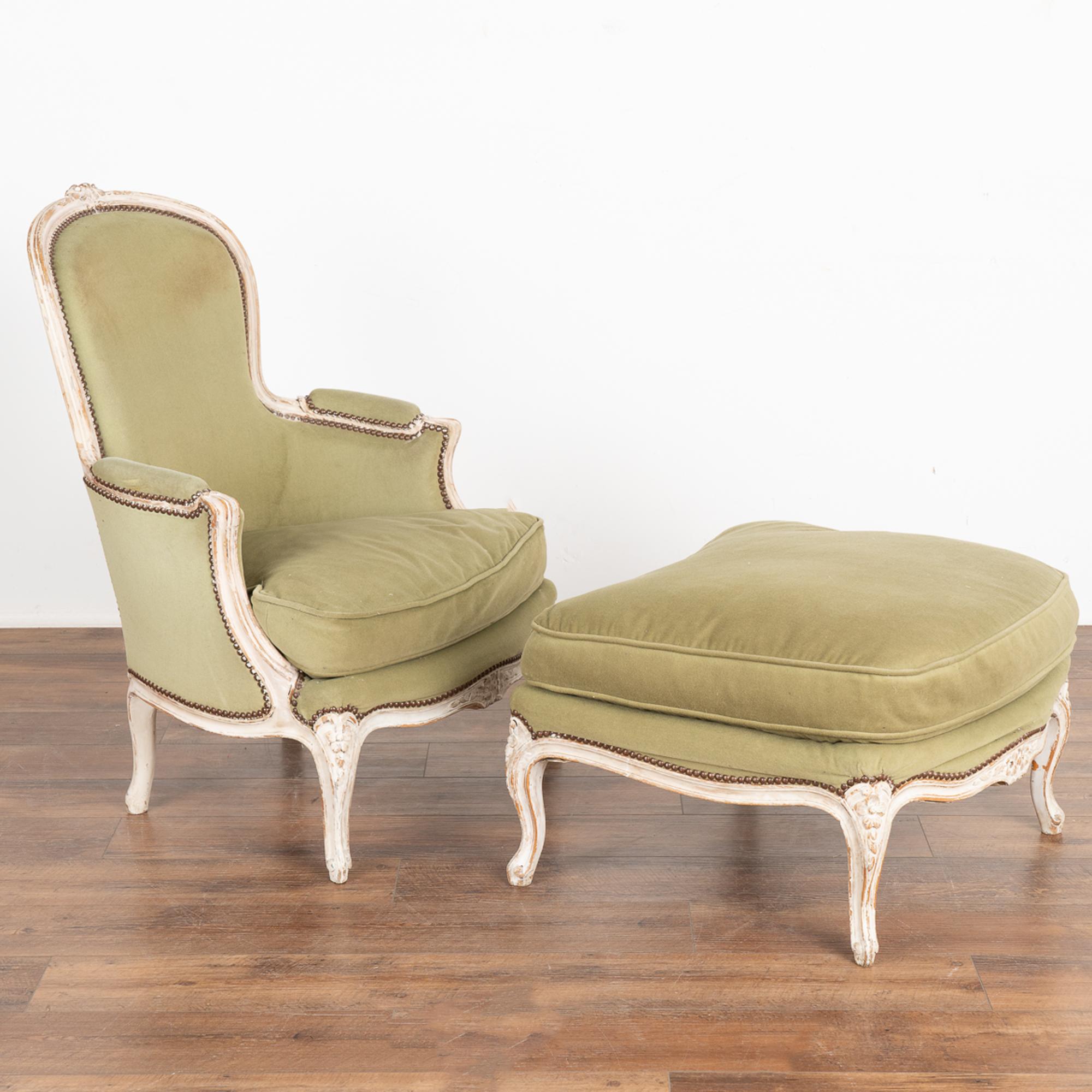 Rococo arm chair and matching ottoman from Sweden circa 1850-70.
Restored, frame is strong/stable. Later professionally painted in layered shades of white and lightly distressed to fit the age and grace of this lovely set.
Older green crushed velvet