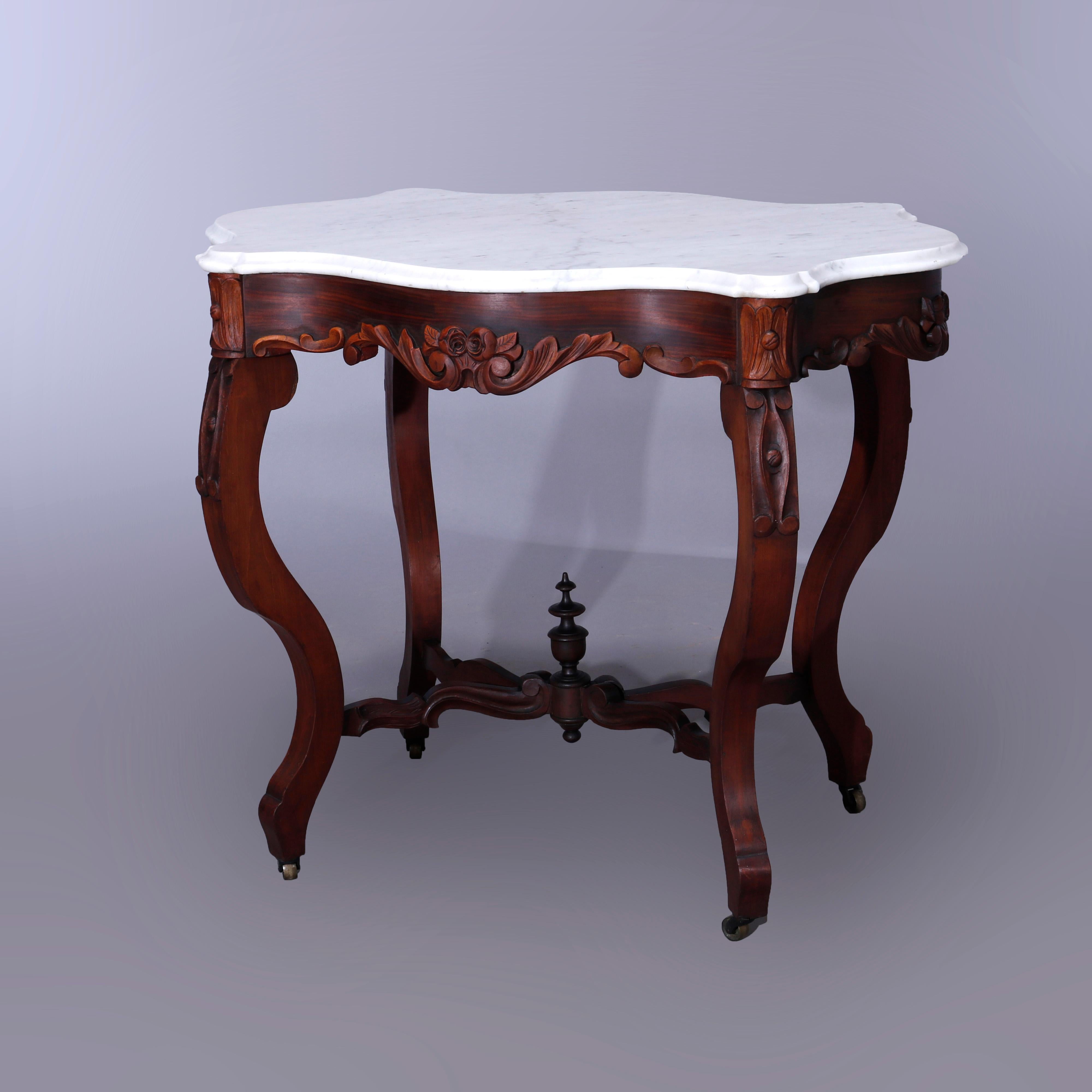 An antique Rococo turtle top parlor table offers beveled and shaped marble top over walnut base raised on cabriole legs with carved foliate knees and scroll form stretcher with central finial, c1880

Measures - 31''h x 37''w x 26.25''d.

Catalogue