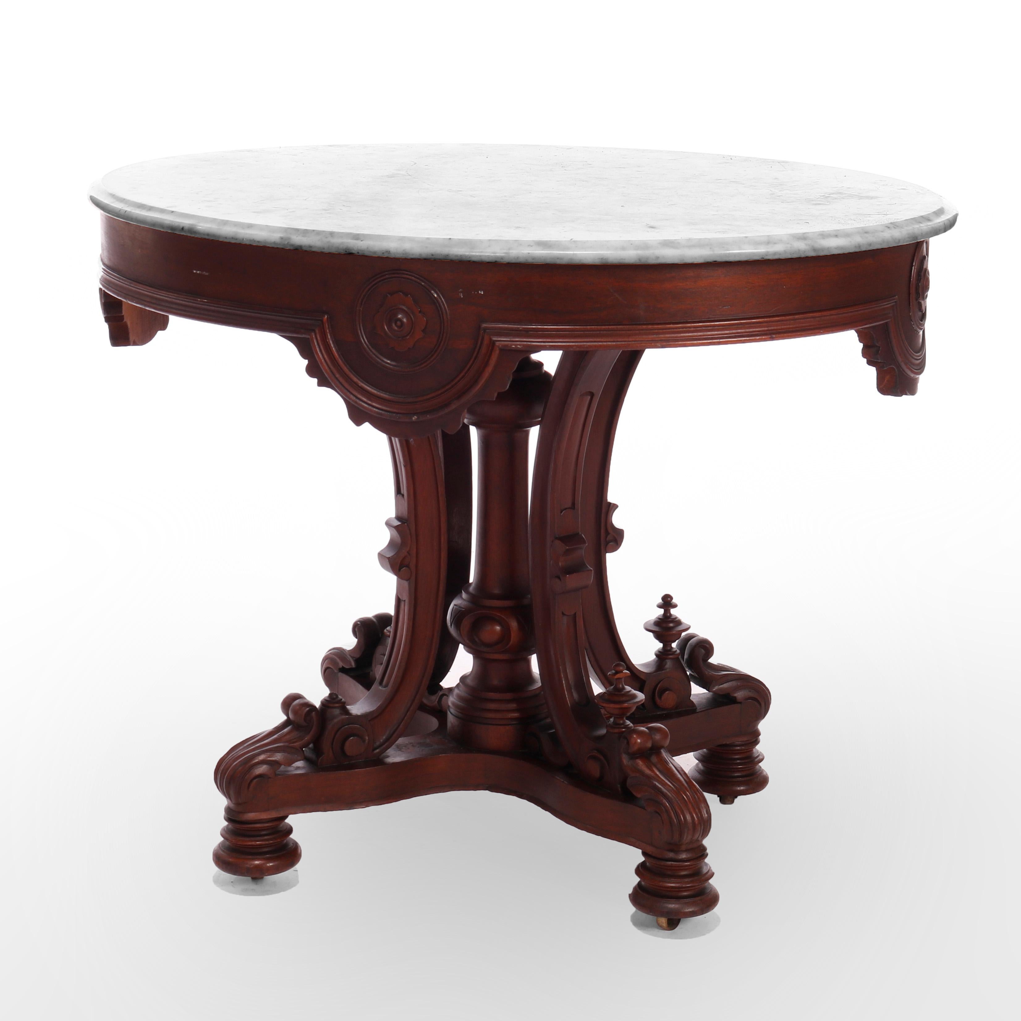 An antique Rococo Revival parlor table offers oval and beveled marble top over rosewood base having shaped skirt and raised on scroll form legs with center turned column, c1870

Measures - 28.5'' H x 36'' W x 27'' D.

Catalogue Note: Ask about
