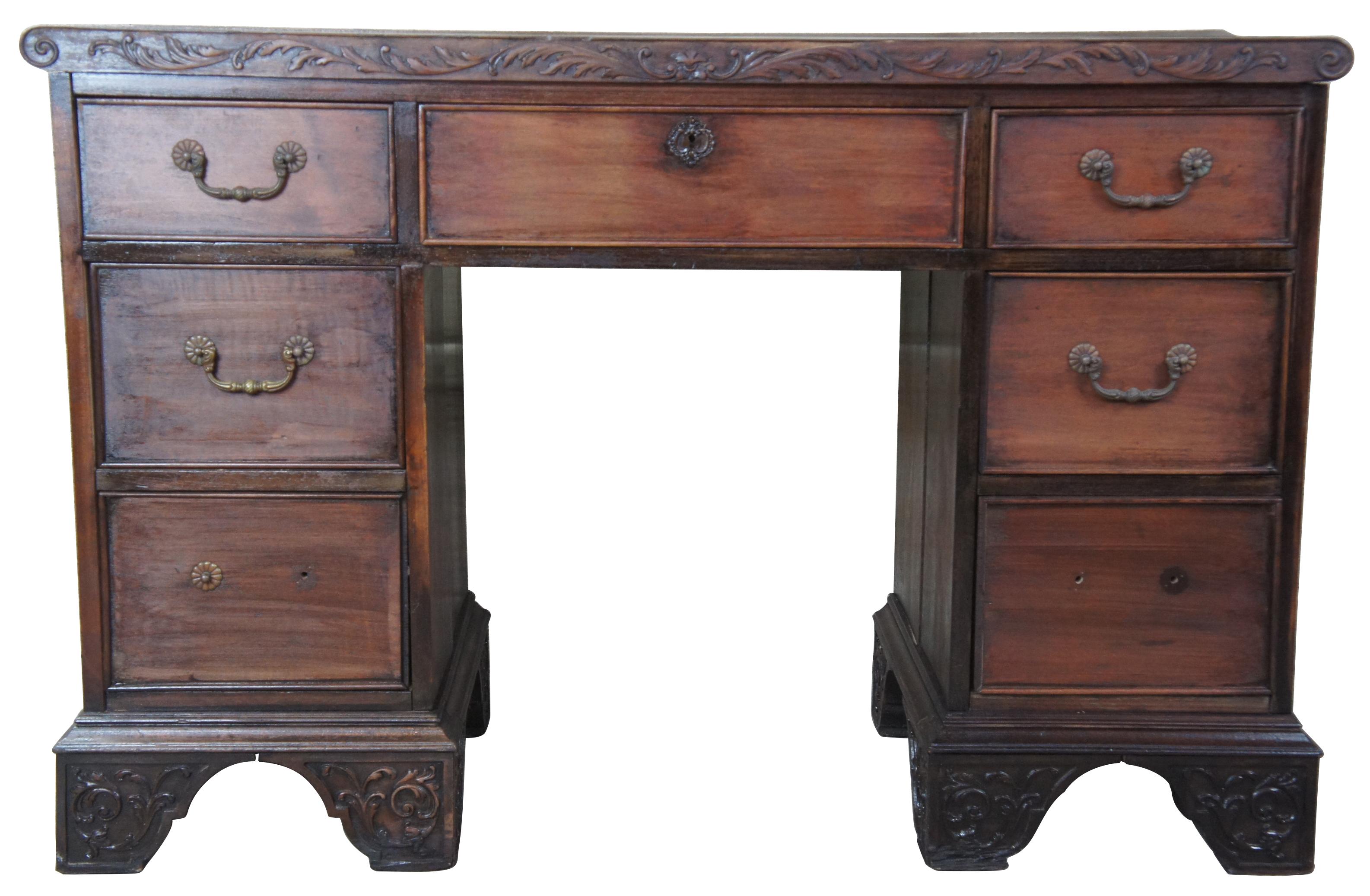 Rococo Revival desk, circa 1940s. Made from walnut with seven drawers and ornately carved detail. Measure: 46