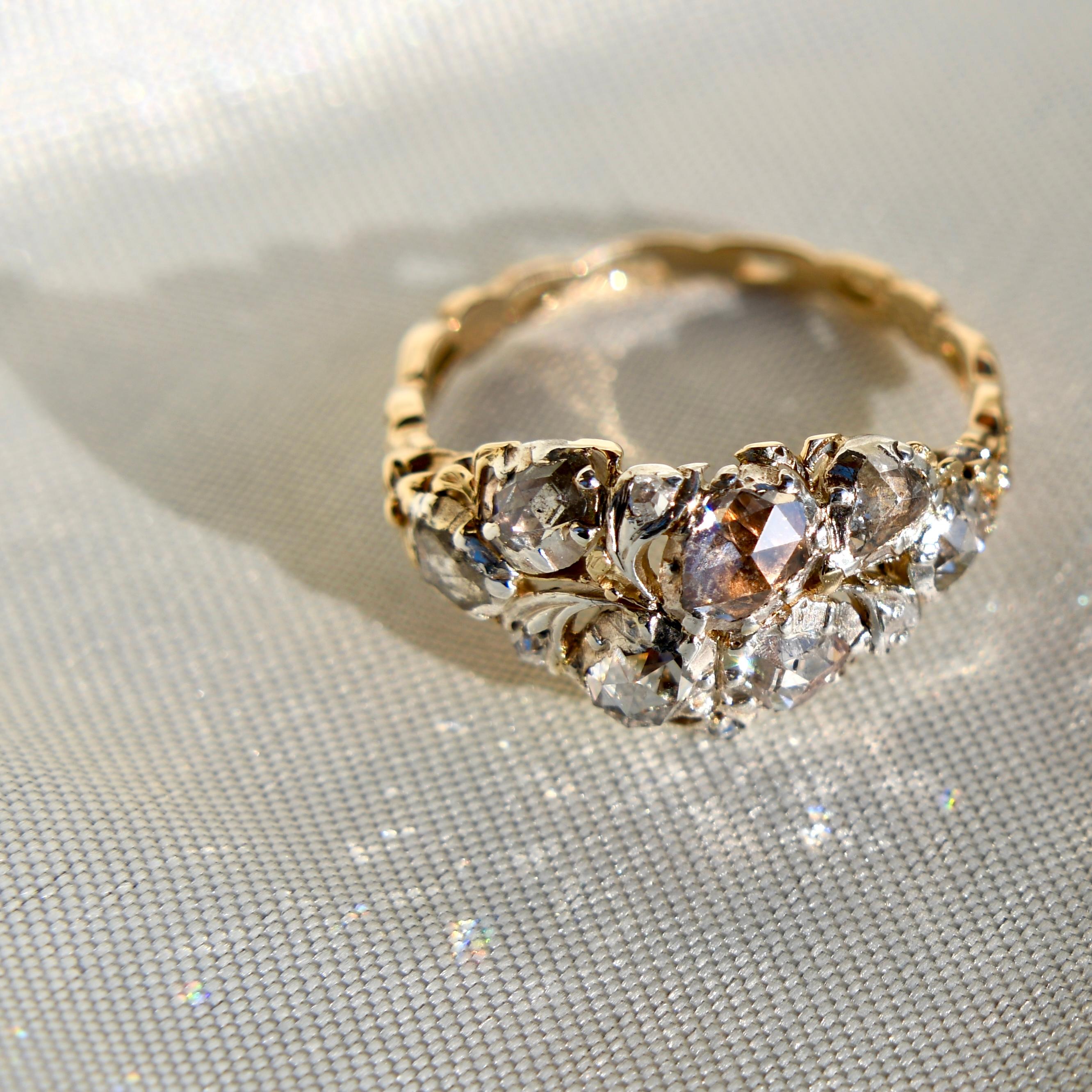 This ring was most likely made in France around 1760 and is in very good, antique condition. 

- Eleven rose cut diamonds, approx. 1.50 ct total 
- 585/ 14 ct yellow gold and silver  
- Ring size: EU 56, UK P, US 7 1/2 (Not sizeable) 
- The ring