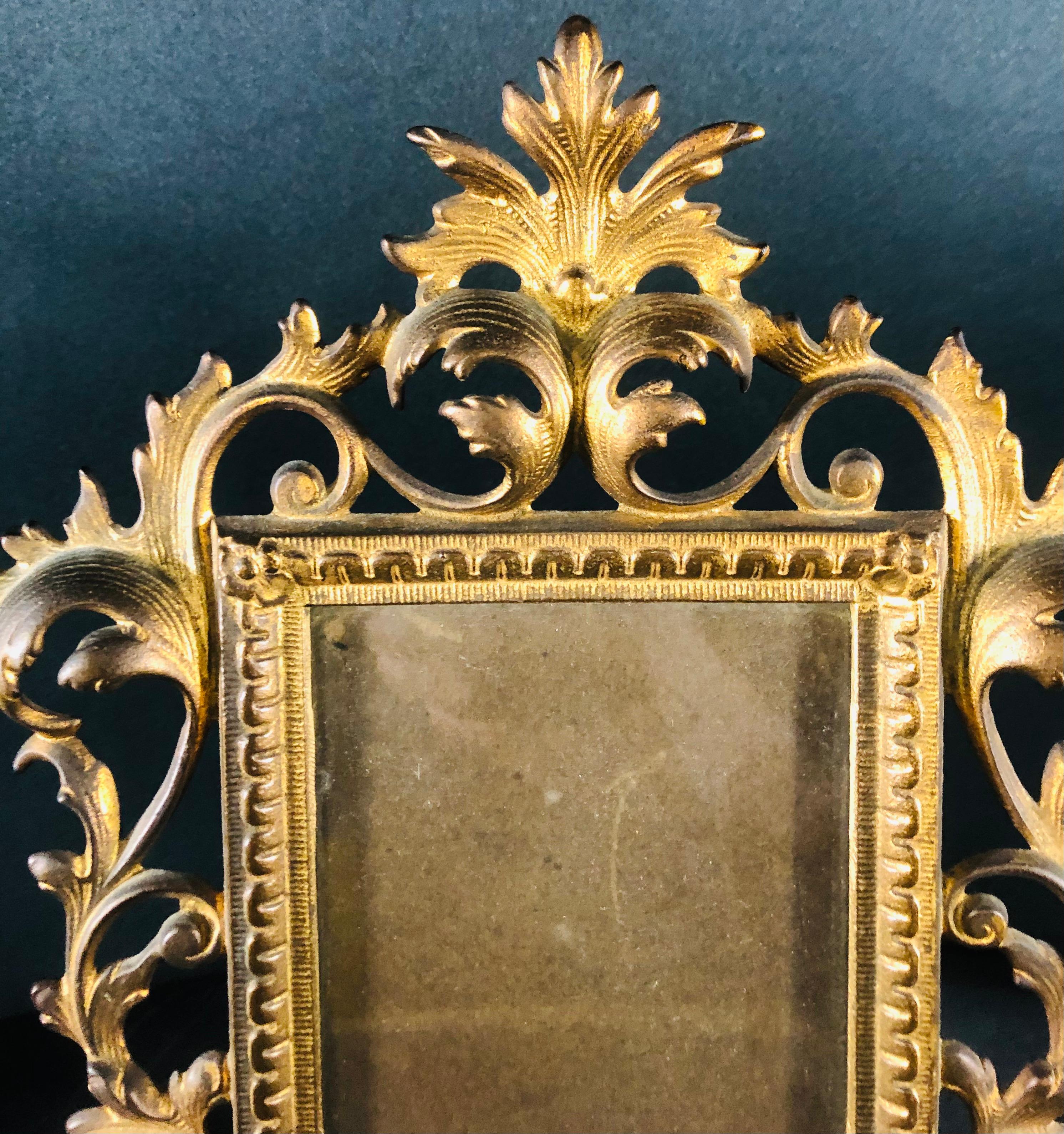 A lovely antique picture frame in Rococo style. Made of brass and finely carved in acanthus leave design. This picture frame will add a classy and elegant touch to decor. 

Measures: Frame 12” H x 9” W x 1” D.