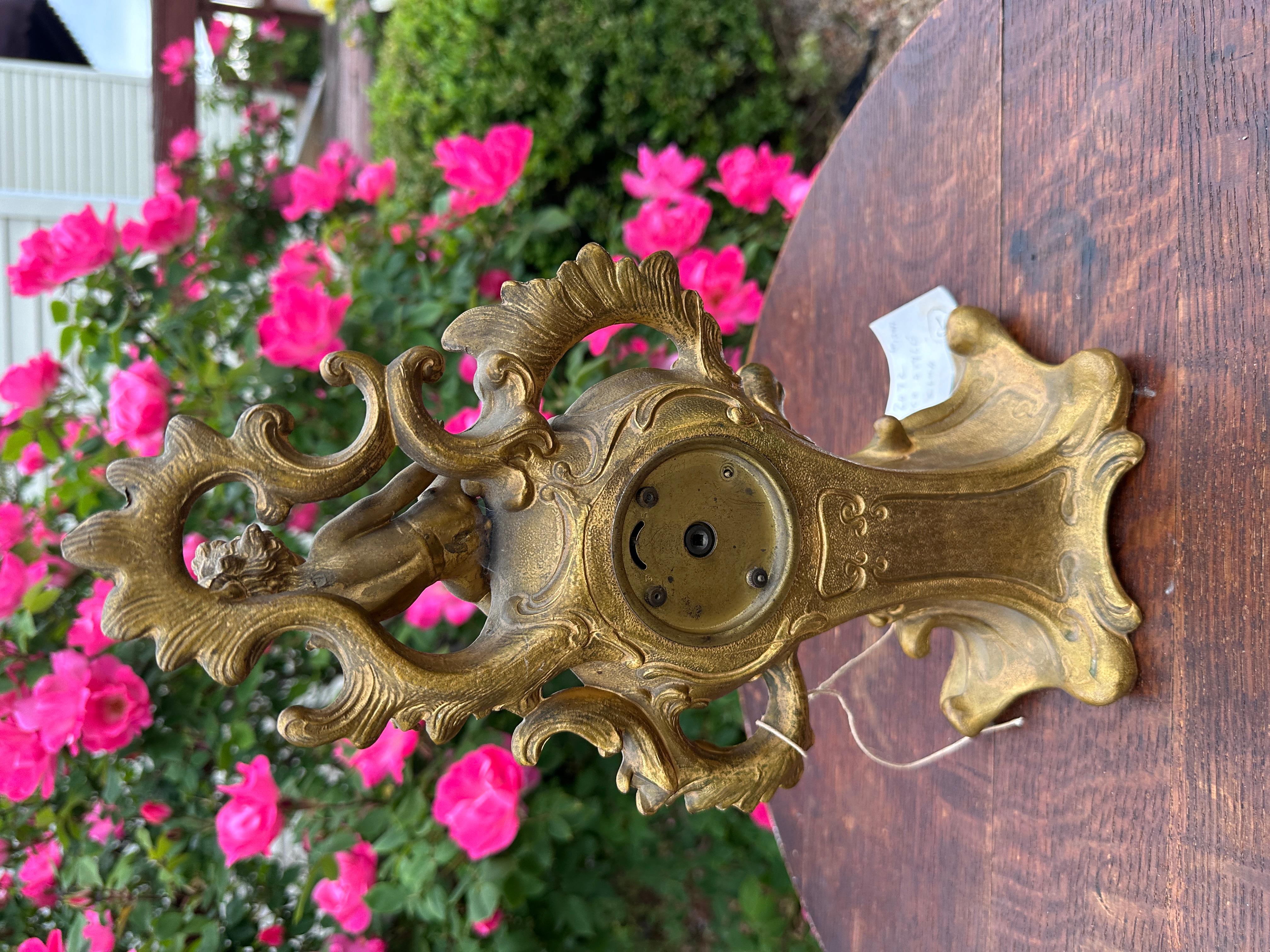 This is an Antique Rococo Style Bronze Clock in working order.  Made by the New Haven Clock Company, New Haven, Connecticut.  There is no damage to this beautiful piece - it has the original face and original patina.   Made  in the early 1930s. 