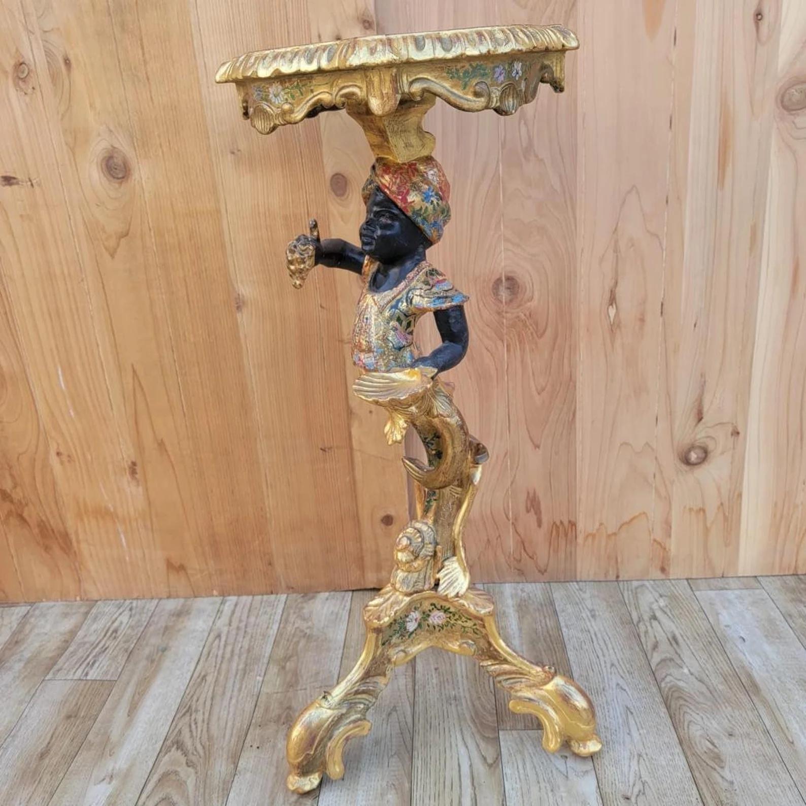 Antique Rococo Style Italian Gilt Blackamoor Side Table/Stand

This Italian 19th Century Rococo style giltwood side table features a man holding grapes over a tripod scrolled base. Discover the exquisite charm of this antique Rococo style table, a