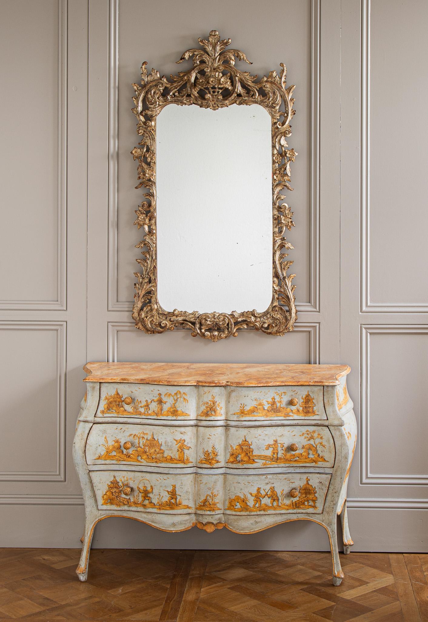 Miroir de style rococo datant du début des années 1900 et provenant de Florence, en Italie. Sculptée à la main avec beaucoup de talent et finie dans une patine traditionnelle 