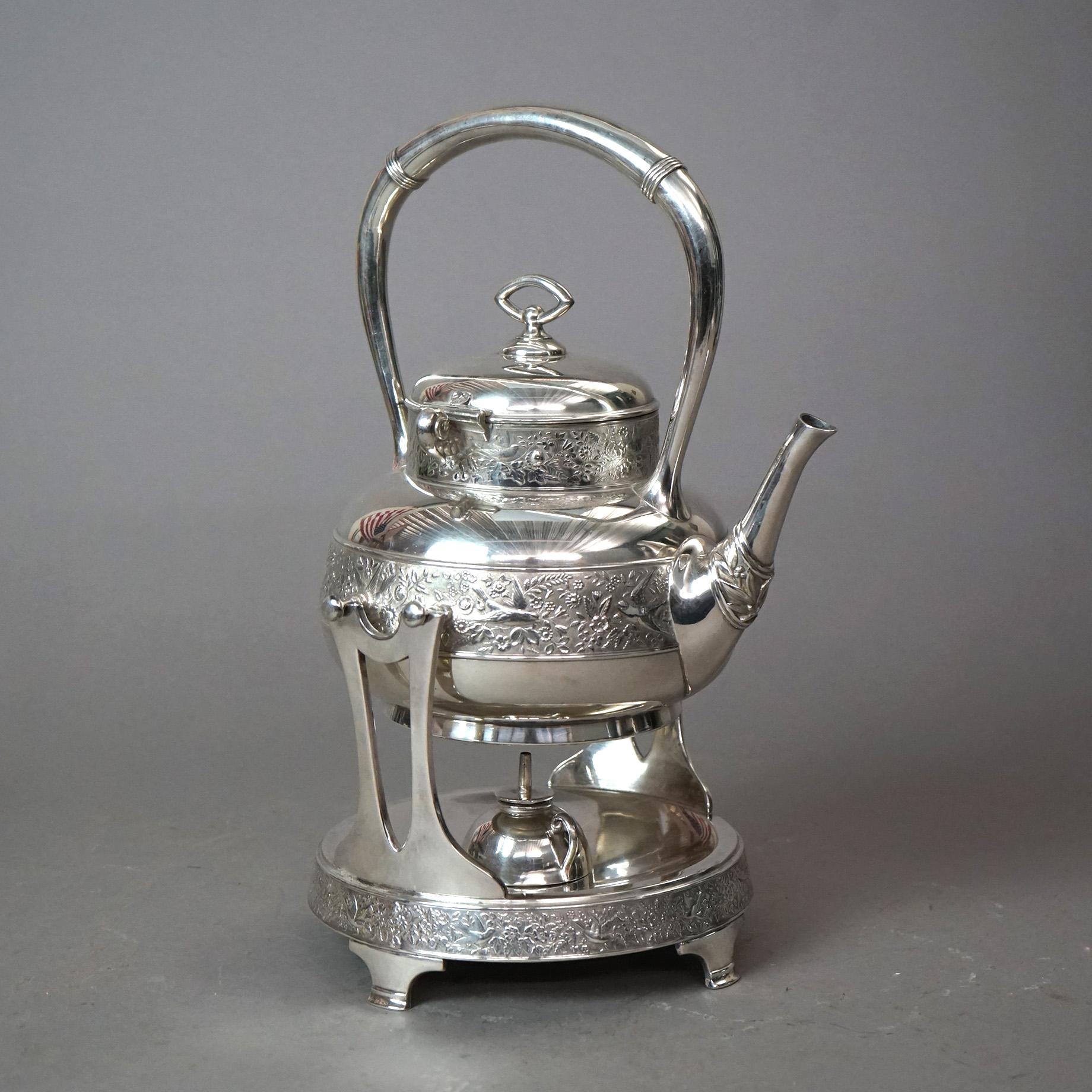 An antique Aesthetic teapot by Rogers offers silver plate construction with tilting teapot having embossed bird and foliate design, seated on heating stand, c1870

Measures - 14.5