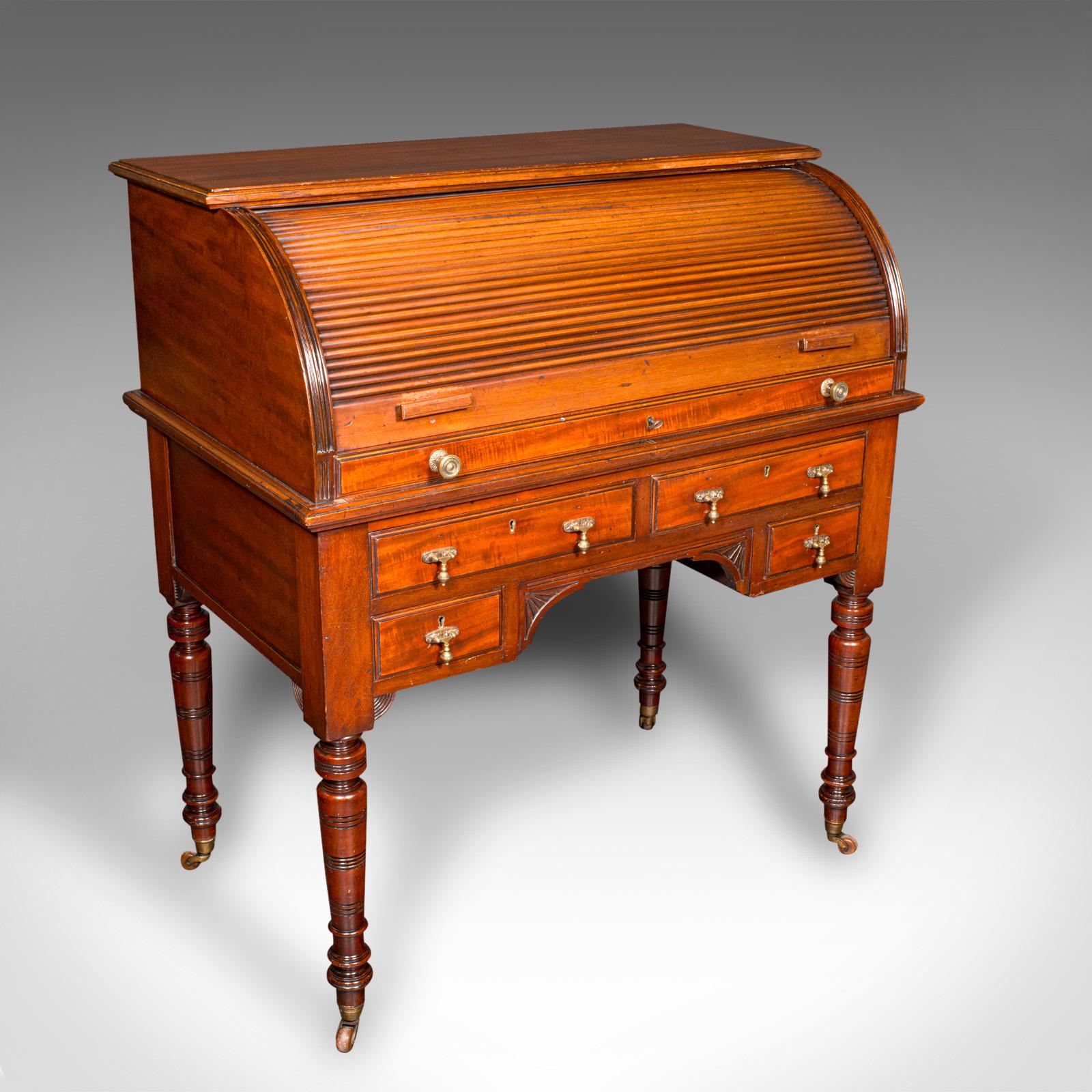 This is an antique roll-top desk. An English, mahogany and leather tambour bureau in Aesthetic Period taste, dating to the late Victorian era, circa 1880.

Beautifully appointed desk, perfect for the drawing room
Displays a desirable aged patina and