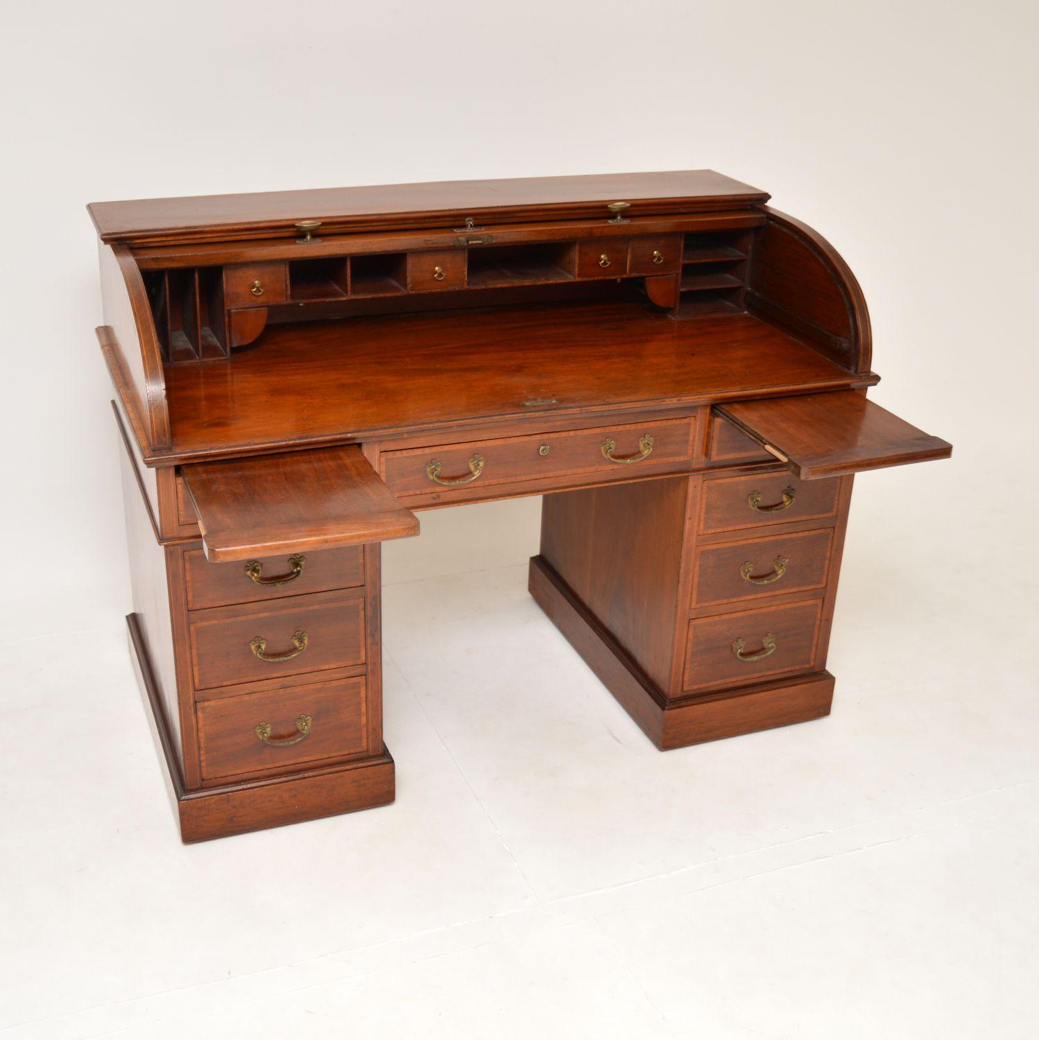 A magnificent antique roll top desk, with satinwood inlays. This was made in England by Waring and Gillows, it dates from around the 1890-1910 period.

It is of absolutely amazing quality, this is like the Rolls Royce of desks, with many fine