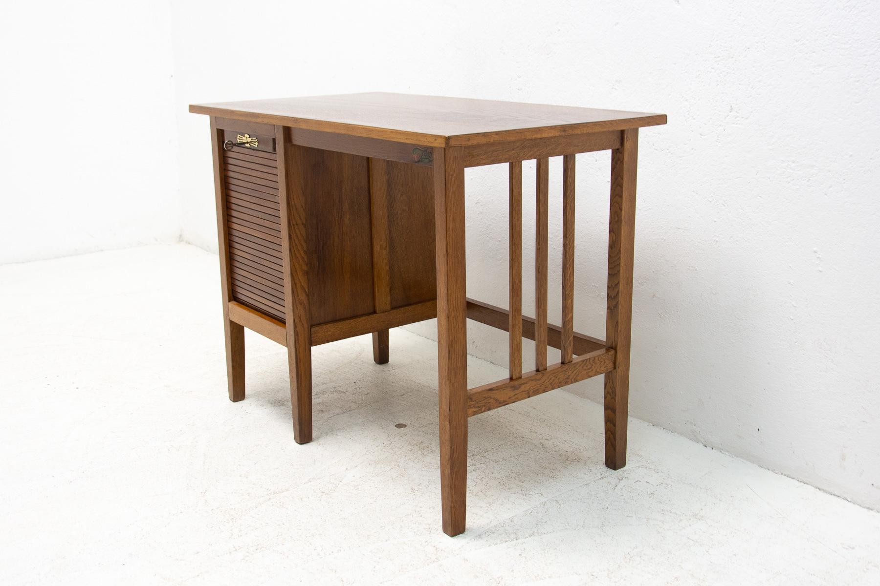 This so-called “American” roller blind desk was made in Bohemia by Jerry company in the 1930s. It is made of stained oak wood. This is one of the most interesting variants of this table.
Completely renovated, in excelent condition.

Measures: