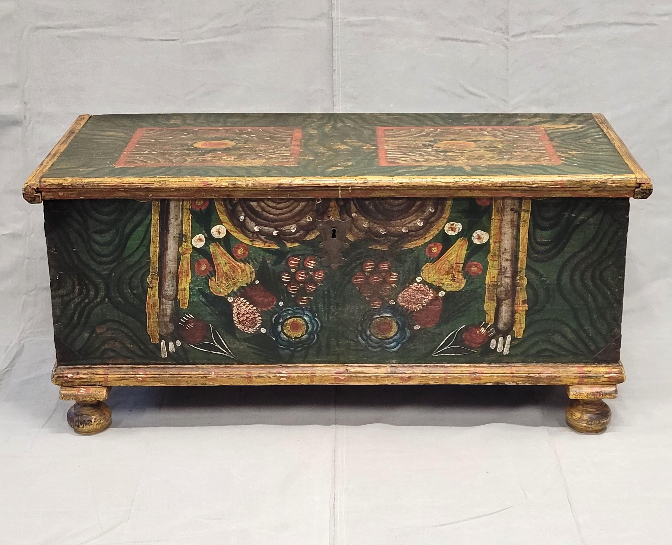 An absolutely charming antique Romanian or eastern European painted blanket chest. Original paint in shades of green, yellow, red, blue and black. Original iron hardware. Using this piece as a coffee table or at the foot of the bed makes a stunning