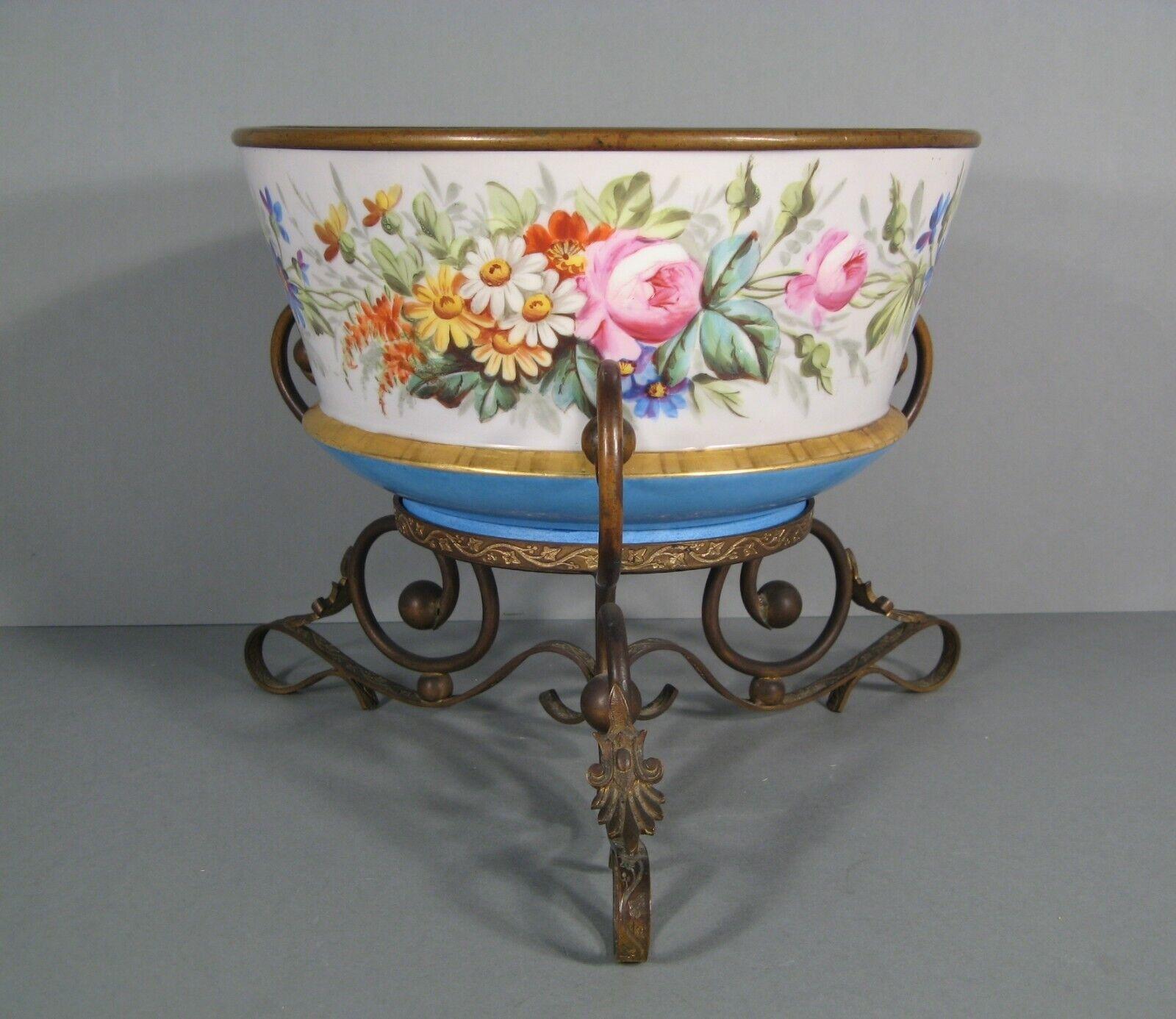 This charming antique fruit coupe features a beautifully painted and gilded porcelain bowl, elegantly mounted on a brass frame. The design showcases Romantic-style floral and botanical elements, making it a stunning addition to any collection or