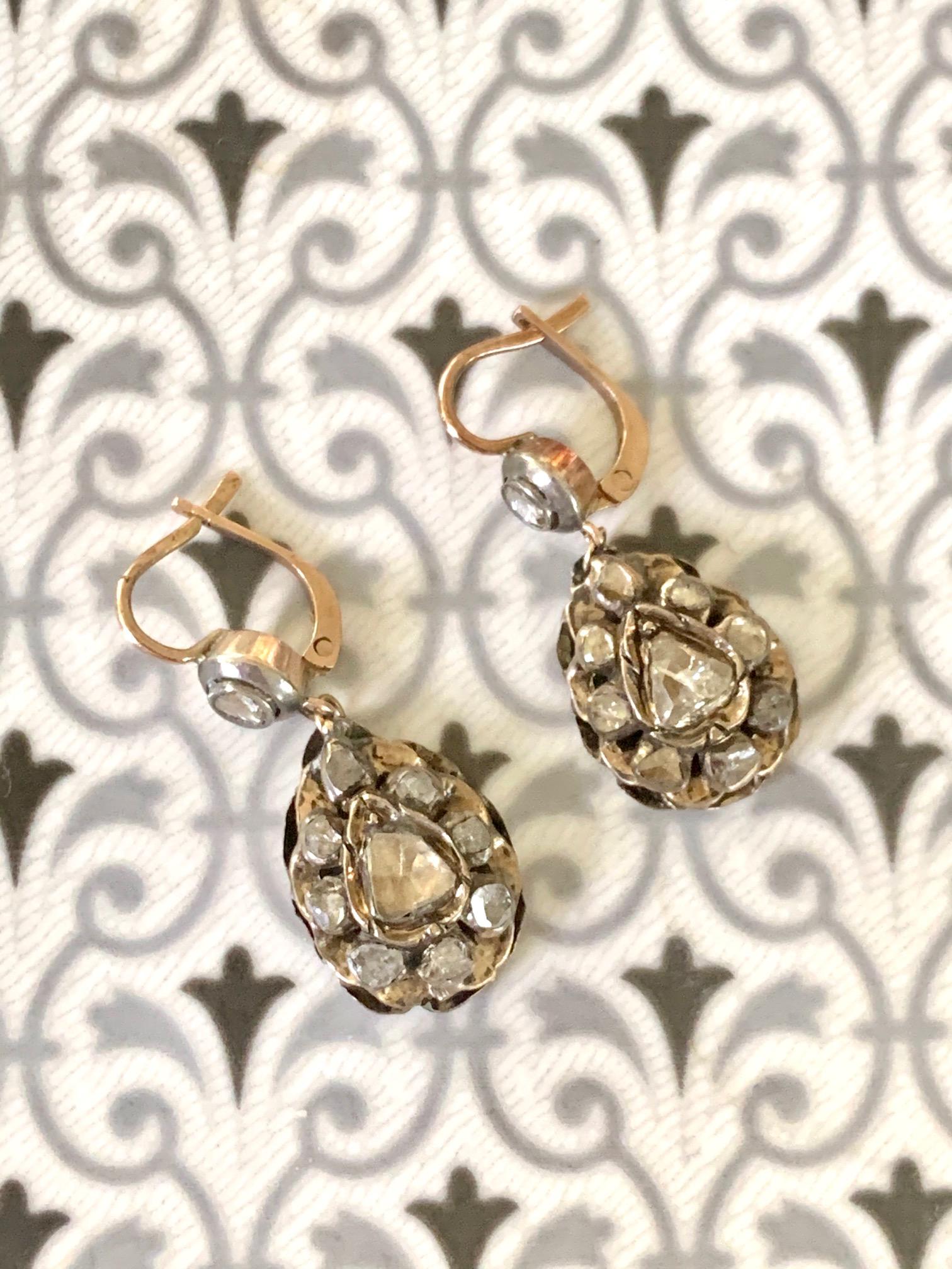 These lovely antique Diamond drop earrings feature several rose cut Diamonds on each earring.  They are set in 9 kart Gold and Silver.  The closure is a French hook for extra security.

Length:  1 1/4