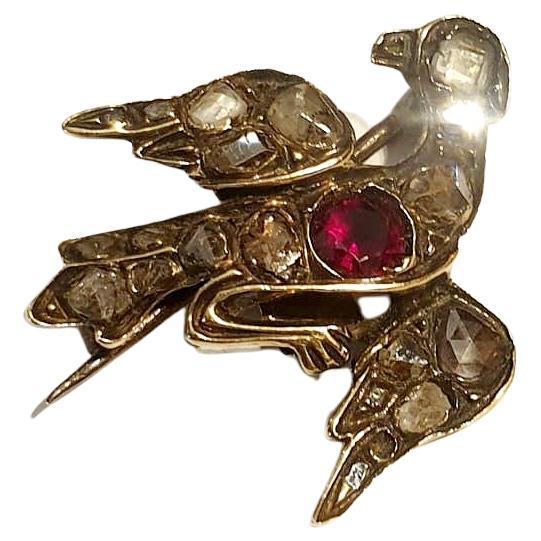 Antique victorian era swallow bird brooch and pendant with rose cut diamonds centered with natural garnet stone in 10k gold dates back to the victorian era 1850/1870.c