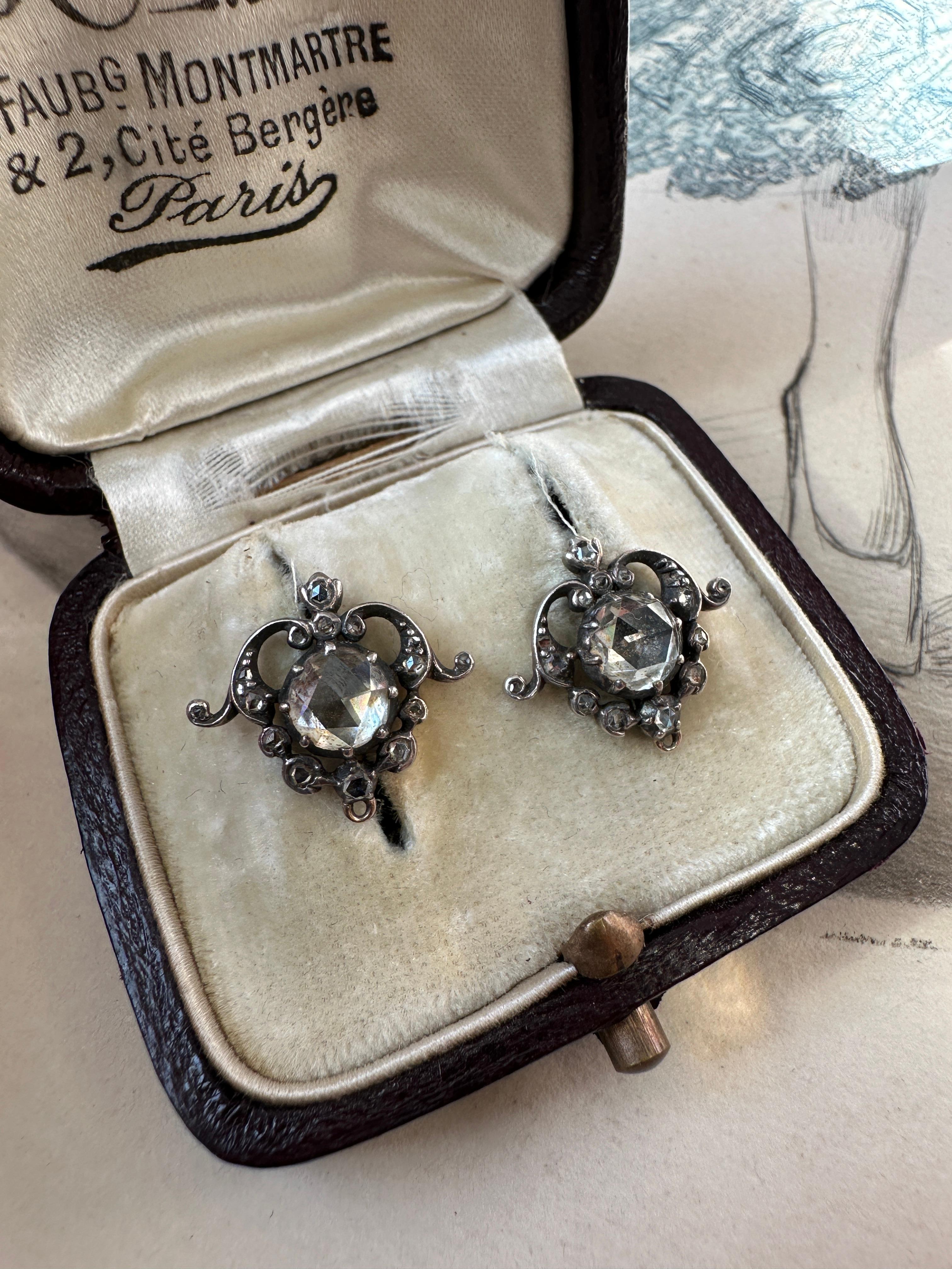 These romantic Victorian conversion earrings are symbolic of love’s burning passion. Centered on a .75 carat rose cut diamond, the heart shaped frame is adorned with tiny glittering rose cut diamonds and aflame with eternal love. The components have