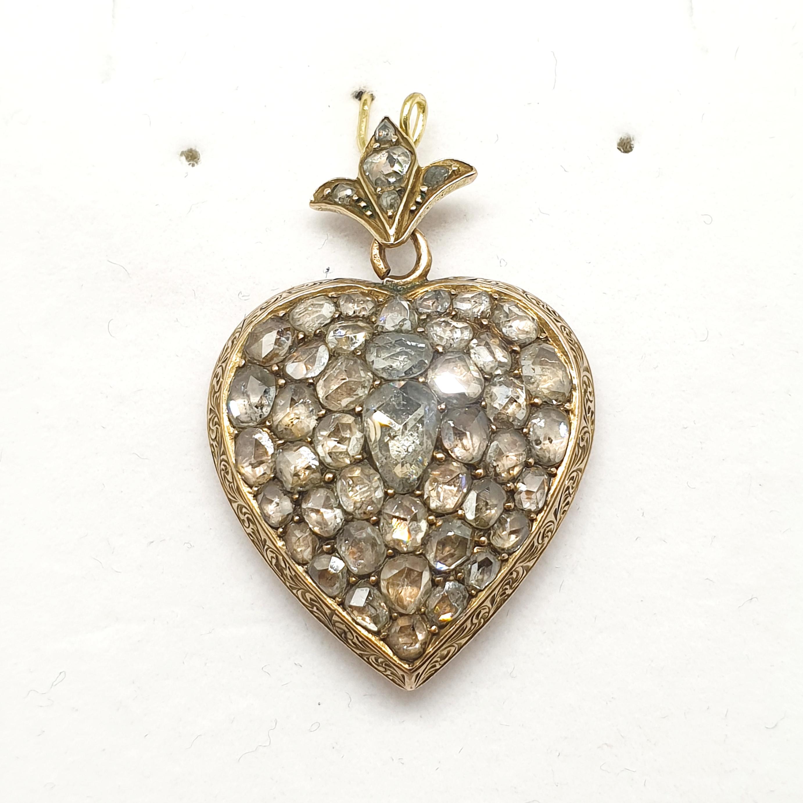 Antique rose cut diamond heart pendant with an estimate diamond weight of 3.5 carats back foiled technique centered with a pear shape rose cut diamond decorted with a lotus flower on top pendant messurments 3.5cm length in 10k gold finest dates back