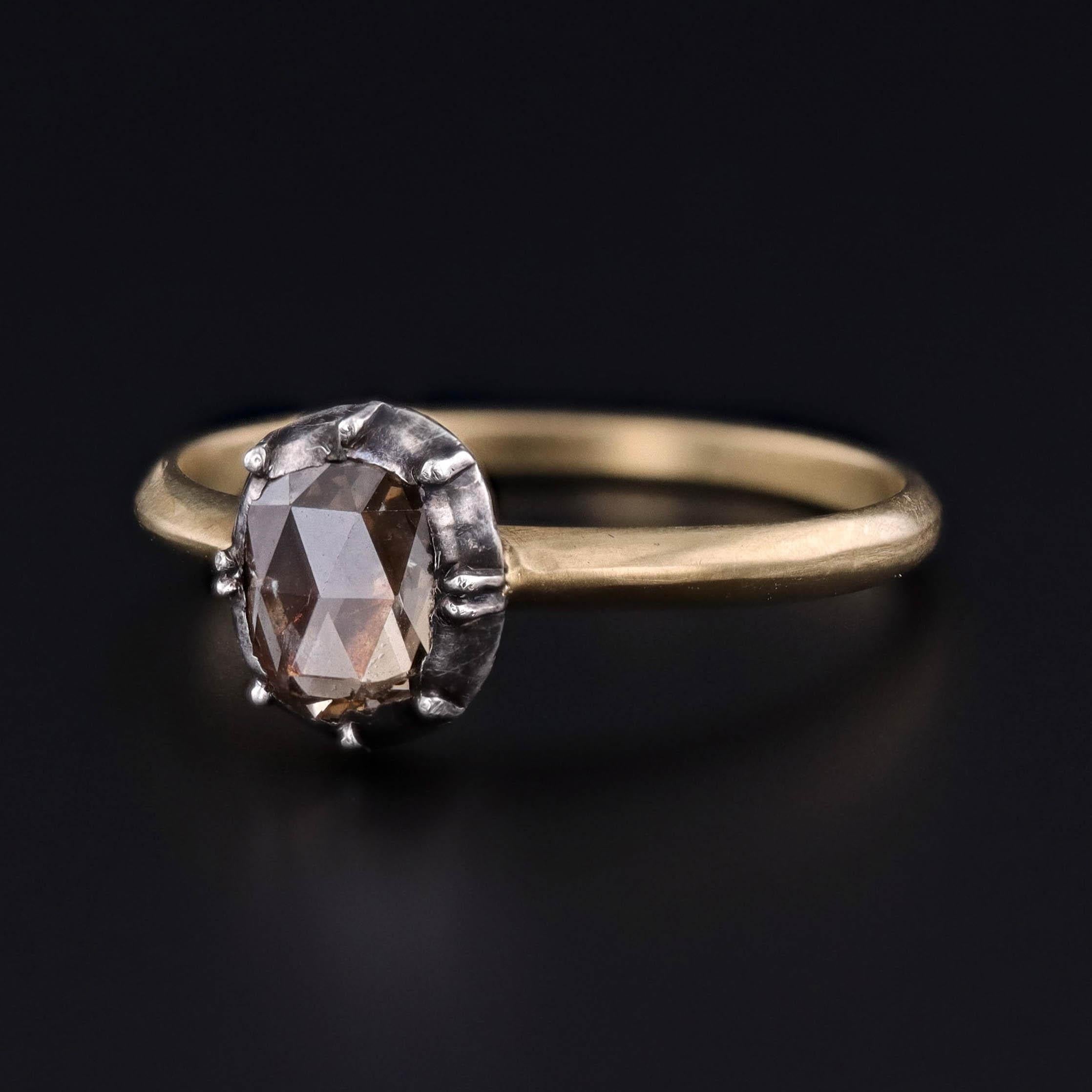 A Georgian era 0.28ct rose cut diamond solitaire conversion ring.  The diamond was originally part of a salvaged antique bracelet.  The stone is set in a closed back, silver rub over mount and our jeweler added a modern, 18k gold band.  

The ring