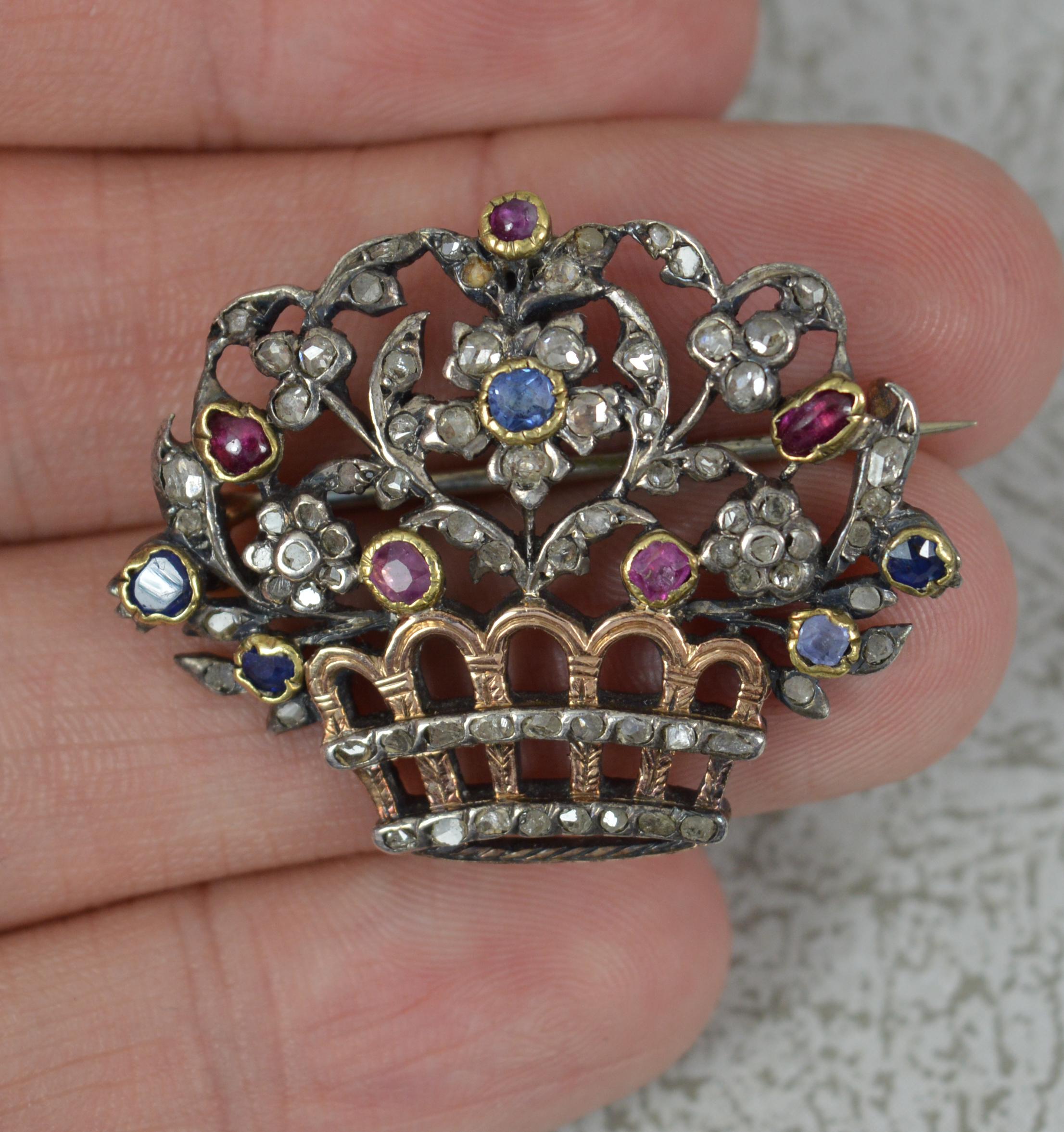 A superb early Victorian period giardinetti brooch.
Very finely made example in silver with rose gold settings, pin sections and basket.
Designed with many rose cut diamonds throughout the flower top and complete with natural rubies and