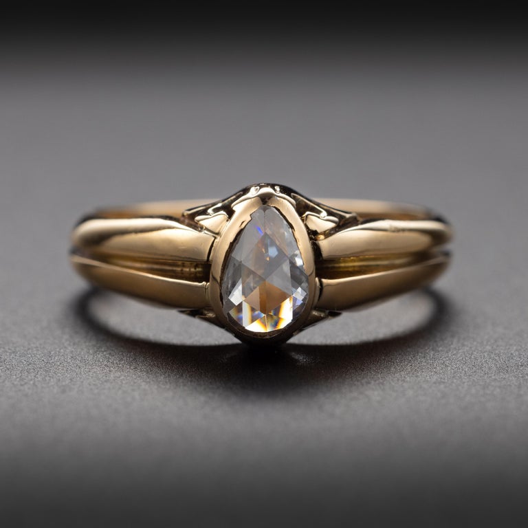 This is an unusually sleek and everyday wearable Victorian-era diamond ring. The low profile -rising just 5.24mm from the surface of the finger- means that you can do such modern things as: place your hands in the front pocket of your jeans, put on