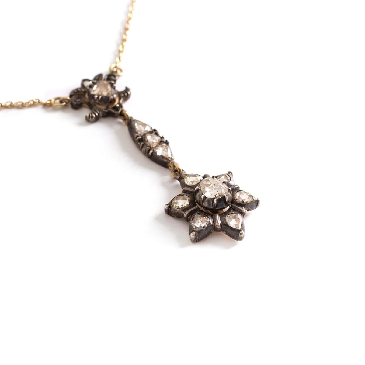 Antique Rose cut Diamond on Silver and Gold Chain Necklace.
Pendant representing a Star.
Pendant length: 4.50 centimeters.
Star's diameter: approximately 16.24 millimeters.
Central rose cut Diameter diameter: 5.60 millimeters.
Chain necklace length:
