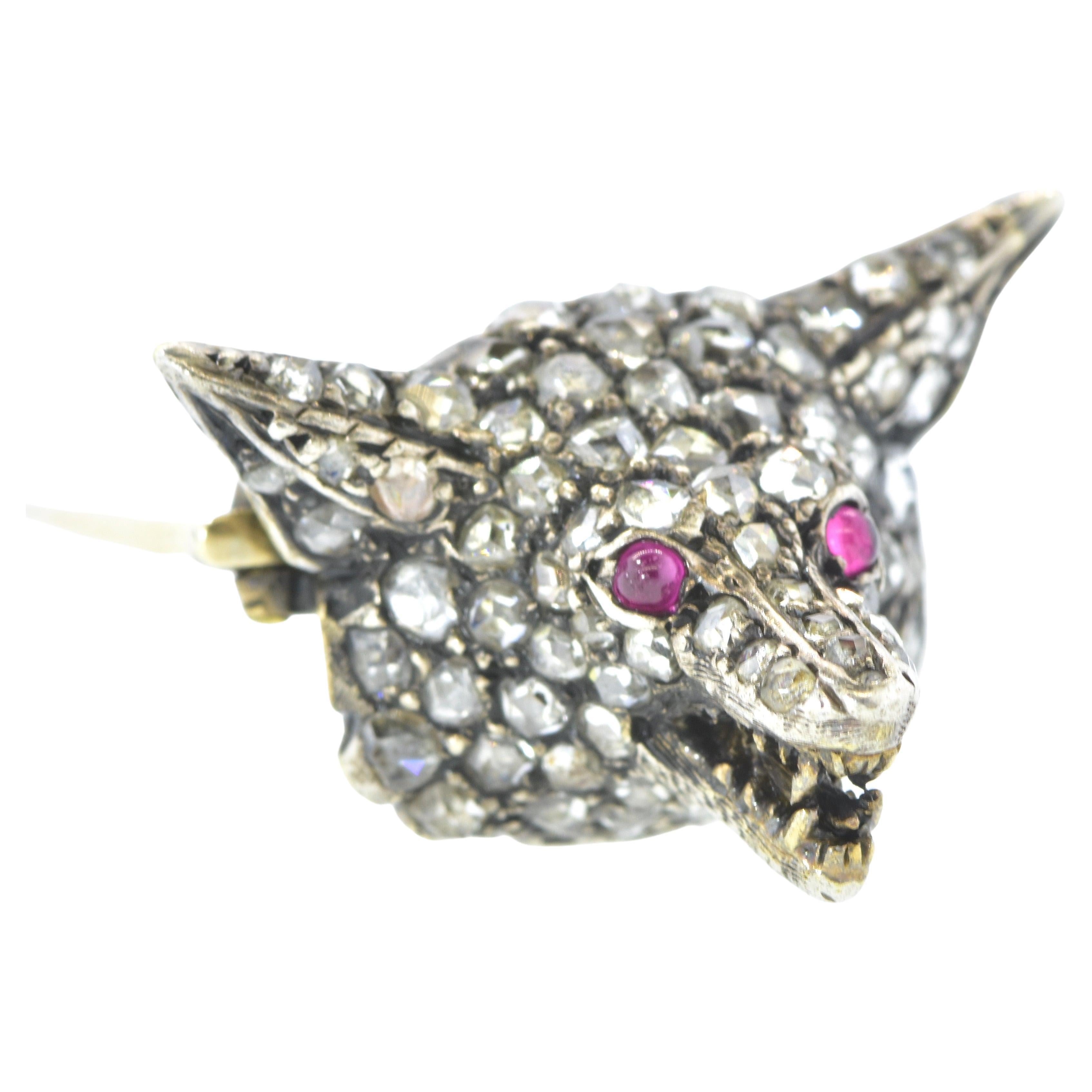 Antique rose cut diamond brooch of a fox head.  A fox for all Seasons!  Nearly 80 rose cut diamonds (about 1 ct.), a pair of small cabochon Burma rubies and both silver and gold (on the back) are employed to create a tour de force of personality and