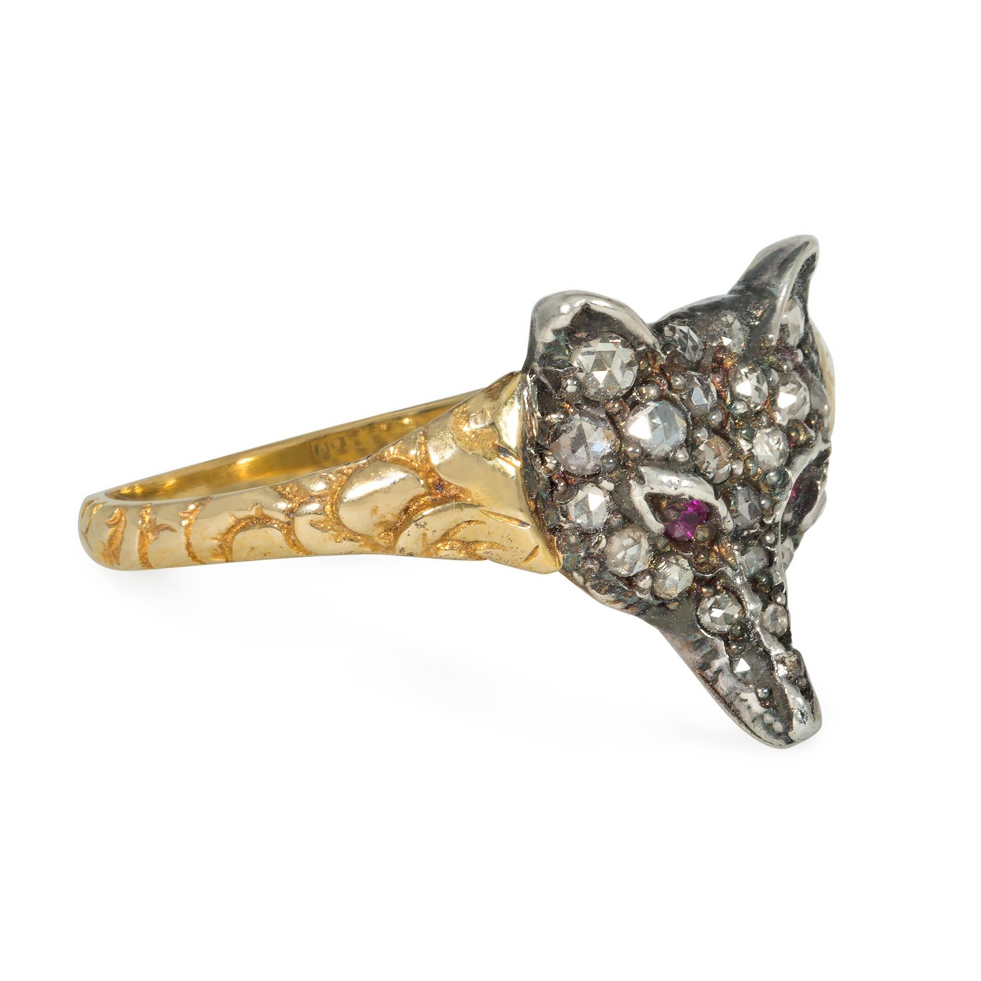 An antique Victorian period diamond and gold fox head ring, the sculpted fox head set with pavé rose cut diamonds and ruby eyes, in sterling silver and 14k with engraved scrollwork on the shank.
Face-up dimensions approximately 7/16