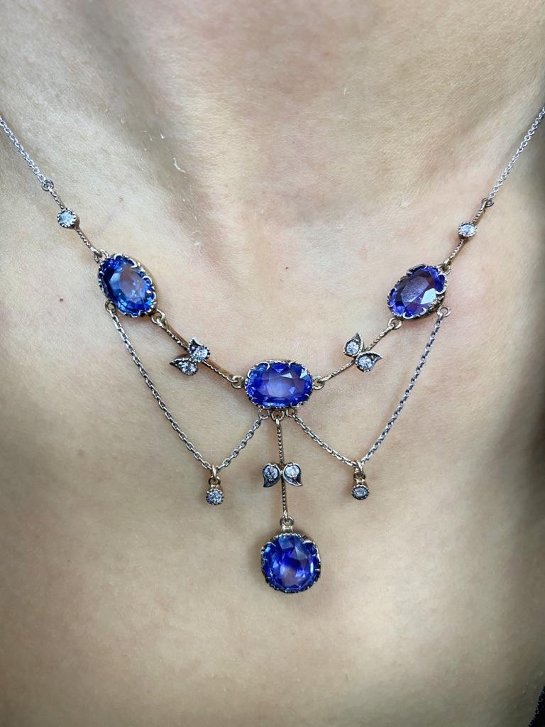 The delicate chain centering 3 oval sapphires ap. 12.50 cts., suspending one oval color-change sapphire ap. 3.75 cts., spaced by 10 old European-cut diamonds ap. .35 ct., c. 1900, ap. 6.8 dwts. Length 17 1/2 inches.

With GIA report no. 5212005471,
