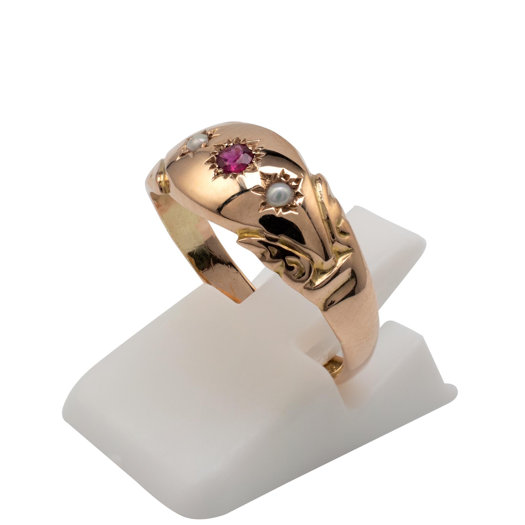 This gorgeous antique English rose gold ruby and pearl gypsy ring is fully hallmarked and dated for London 1918.

The smooth rose gold boat shape setting is set with a round cut ruby to the center with complimenting seed pearls. The stones are set