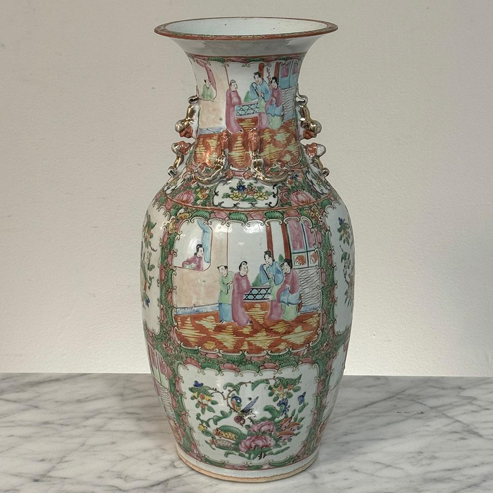 Antique Rose Medallion Porcelain Vase is an exceptionally well-preserved example of the genre.  Designed with eight distinct panels around the main body, it features a continuous panoramic and romantic scene around the neck, interrupted by
