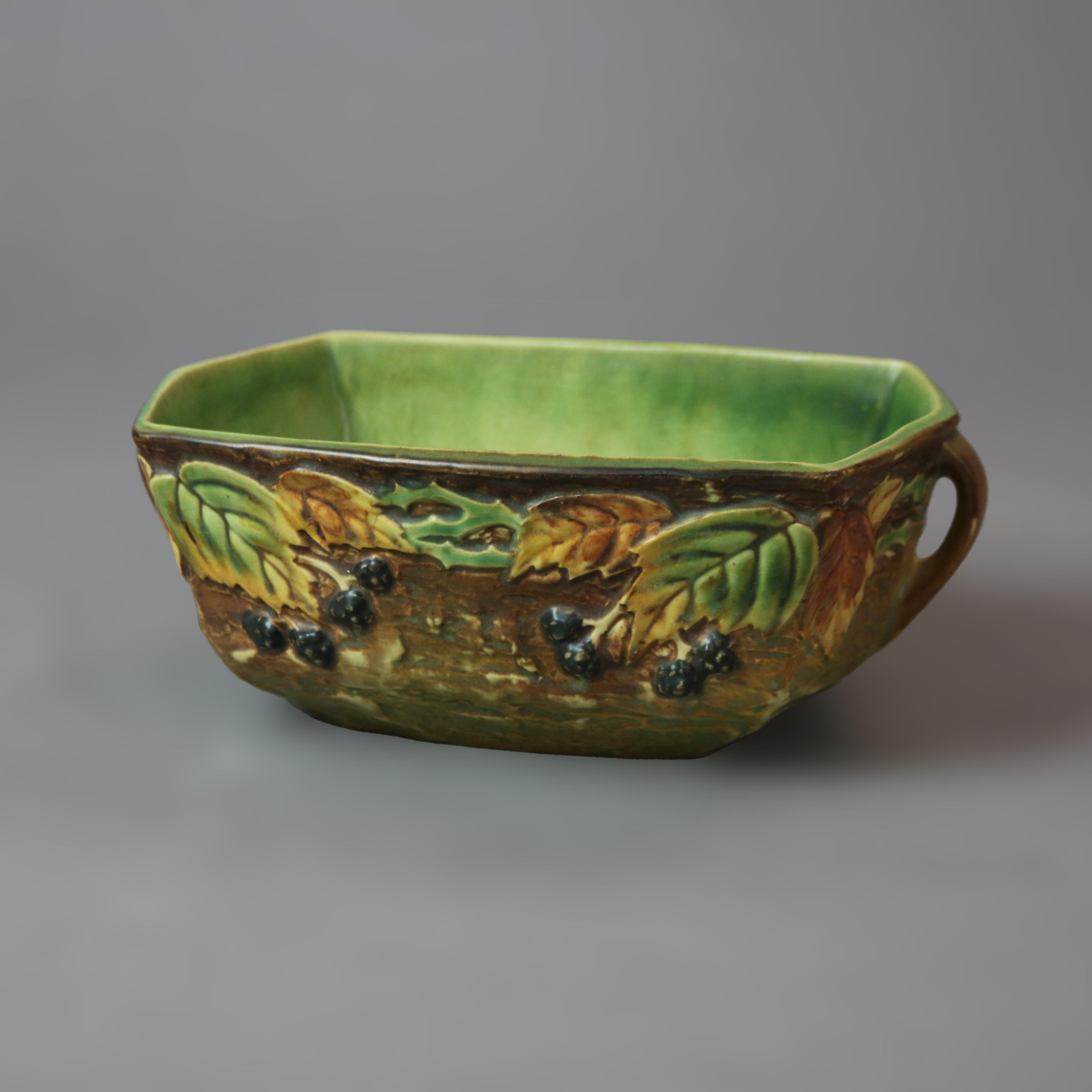 An antique Roseville Blackberry bowl offers art pottery construction with bark form finish and having flanking handles, circa 1930

Measures - 3.75