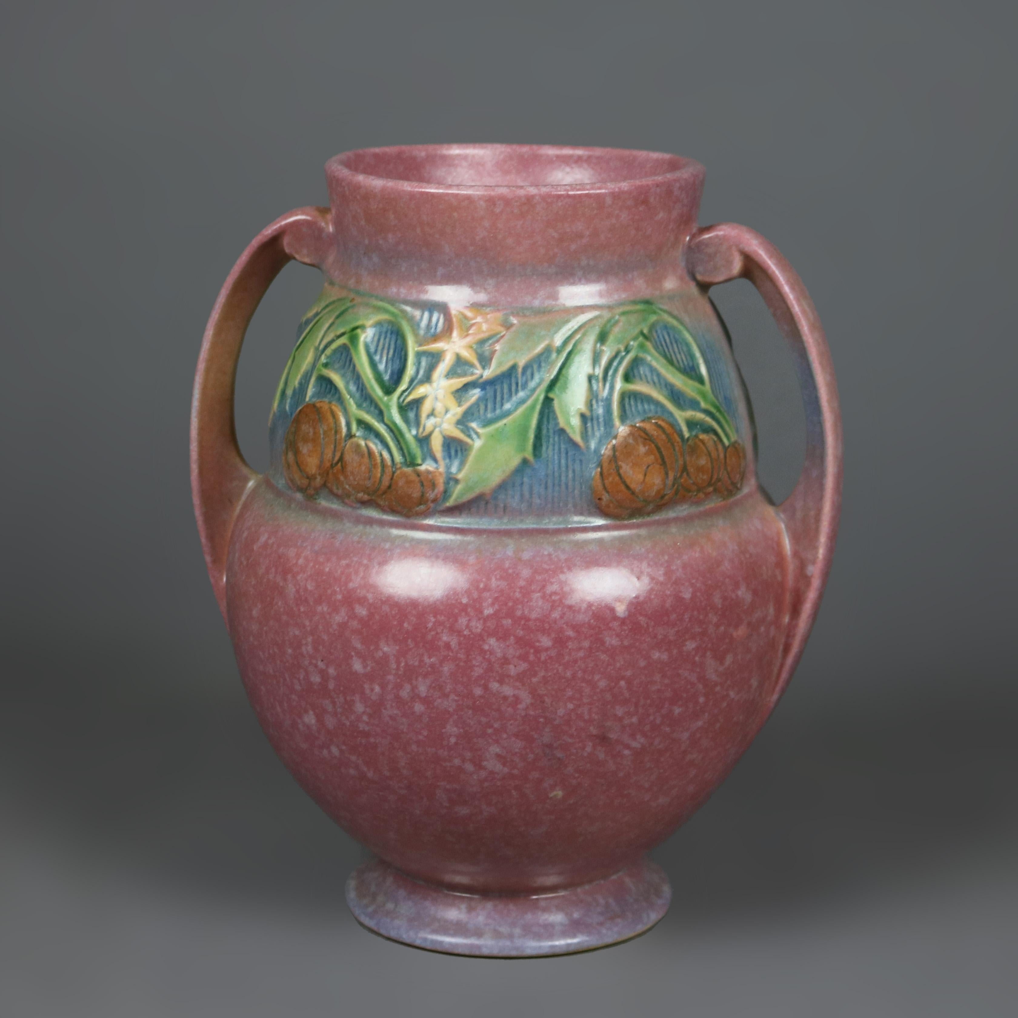 An antique Arts and Crafts vase by Roseville in Baneda pattern offers art pottery construction having pumpkin fruit and leaf band band with double handles, circa 1930

Measures - 9.25