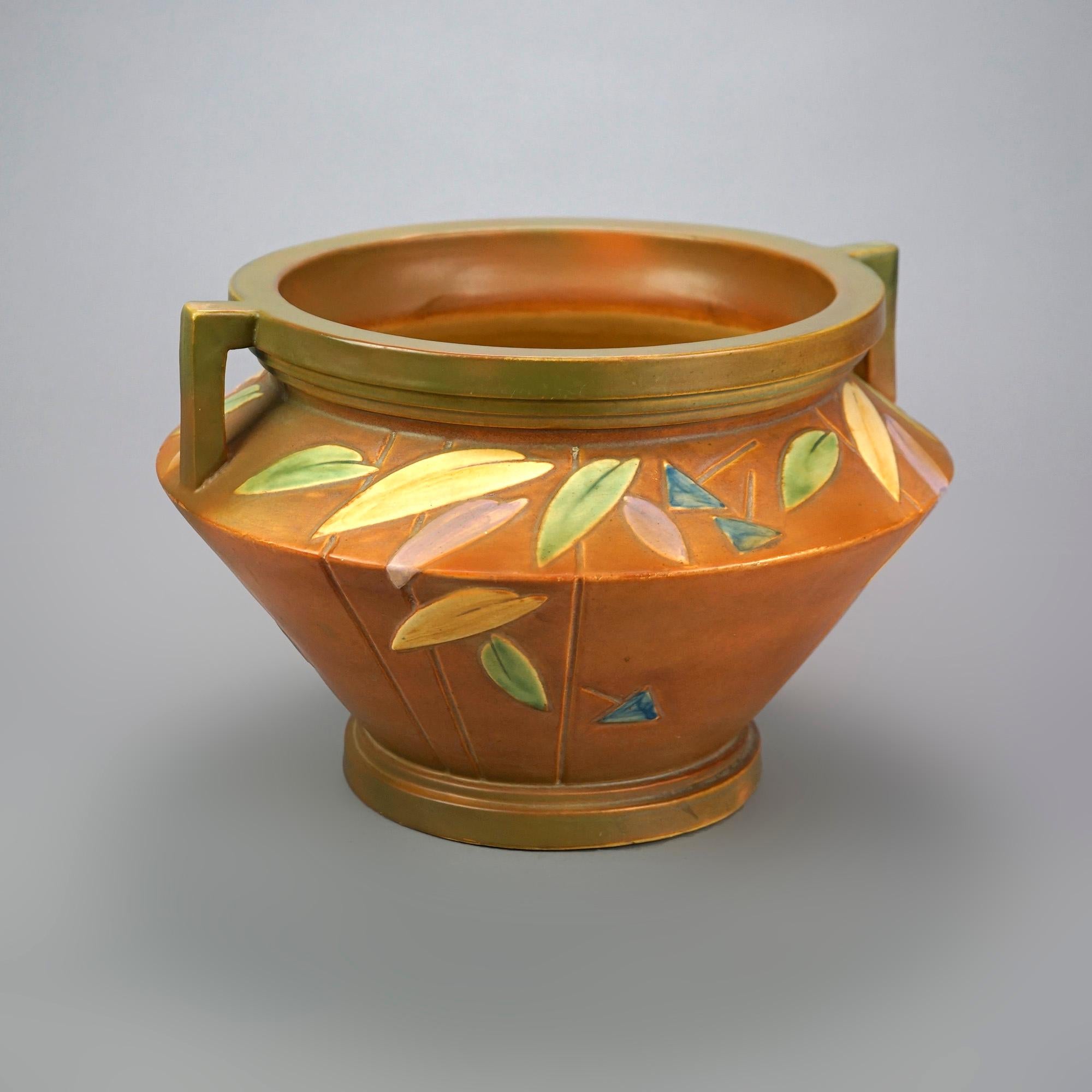 A large Roseville Futura jardiniere offers art pottery construction with fall leaf design and double handles, c1920

Measures- 10''H x 15''W x 15''D.