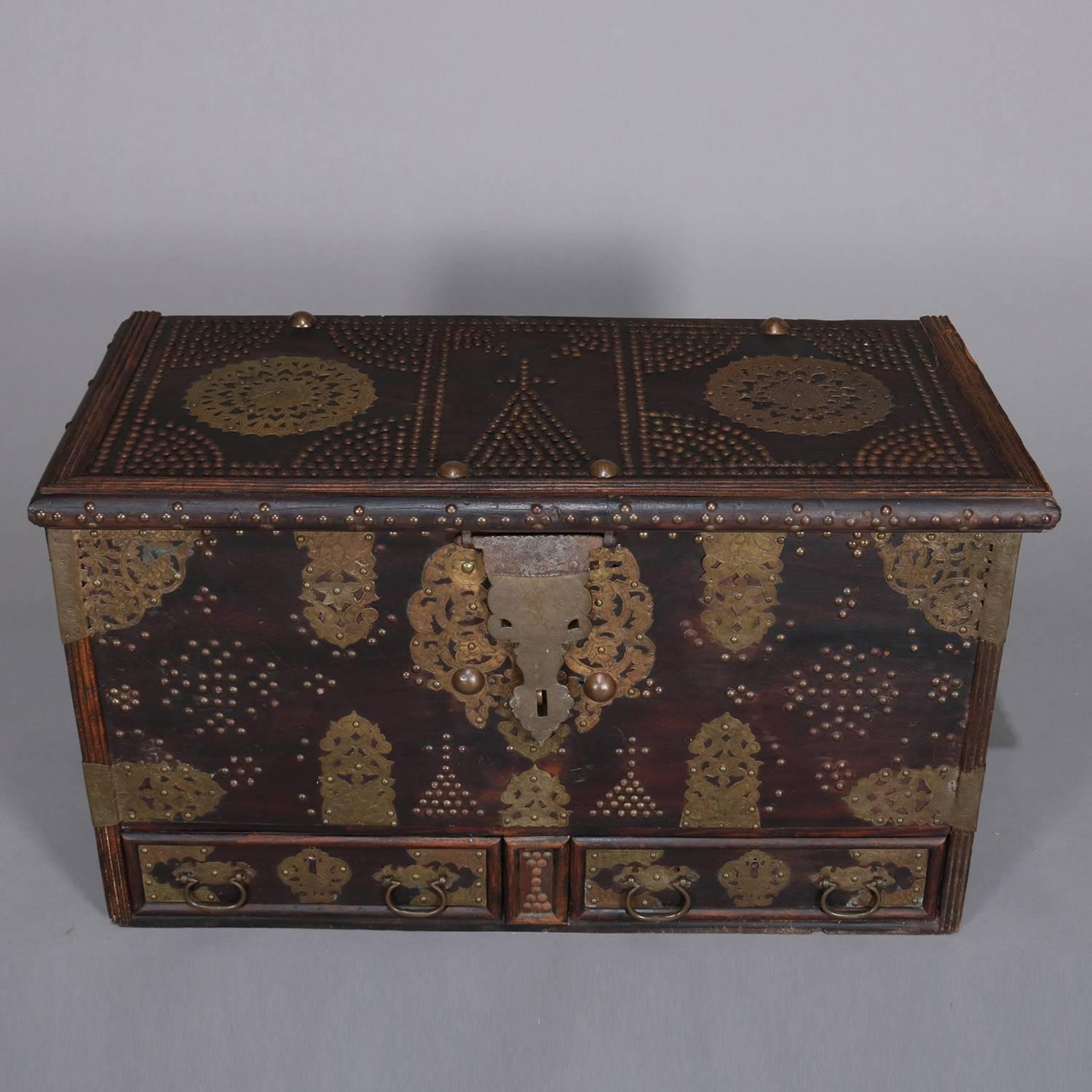 Antique Turkish marital bride's trunk features rosewood construction with two lower drawers and interior patch box; floral pierced and embossed brass reserves, straps, hinges, handles and hasp; patterned design in brass tacks including church or