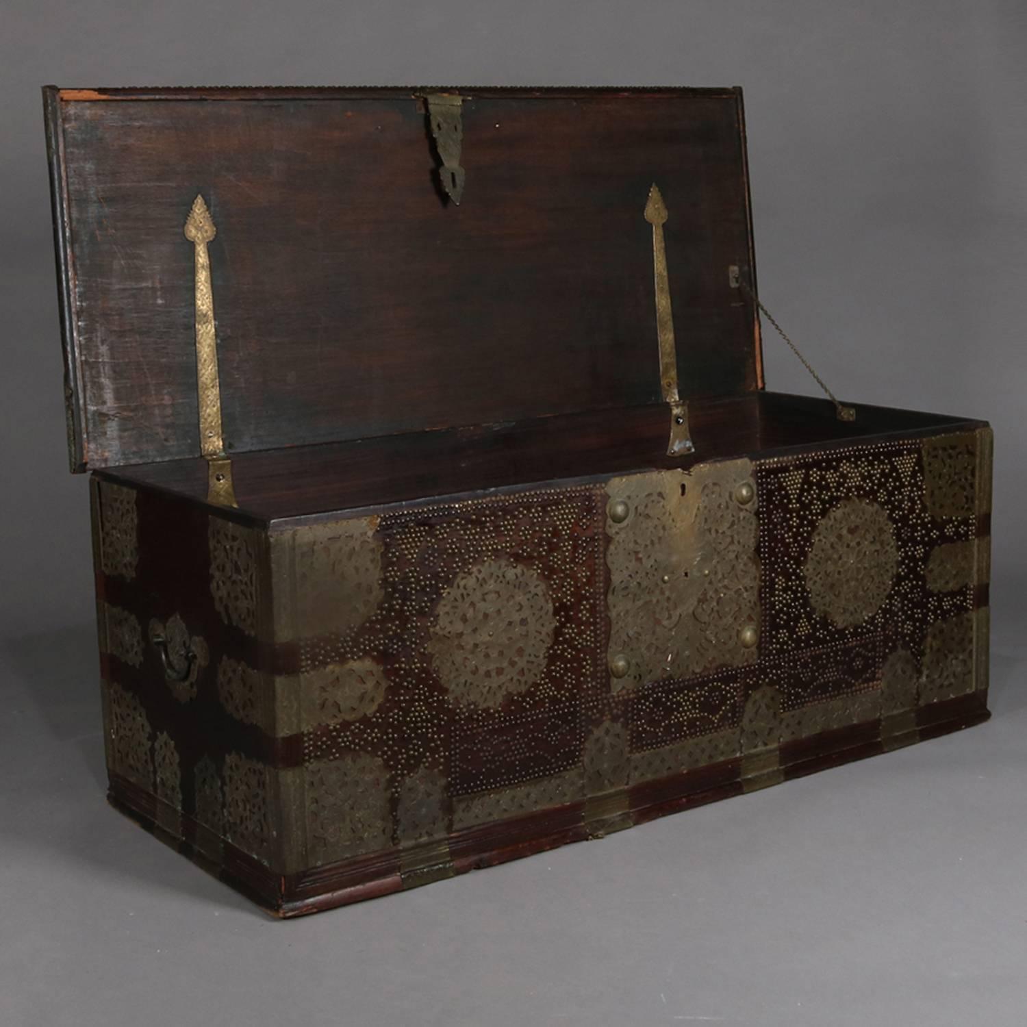 Antique Turkish marital groom's trunk features rosewood construction; floral pierced and embossed brass reserves, straps, hinges, handles and hasp; patterned design in brass tacks including church or mosque; early 19th century.

Measures: 23