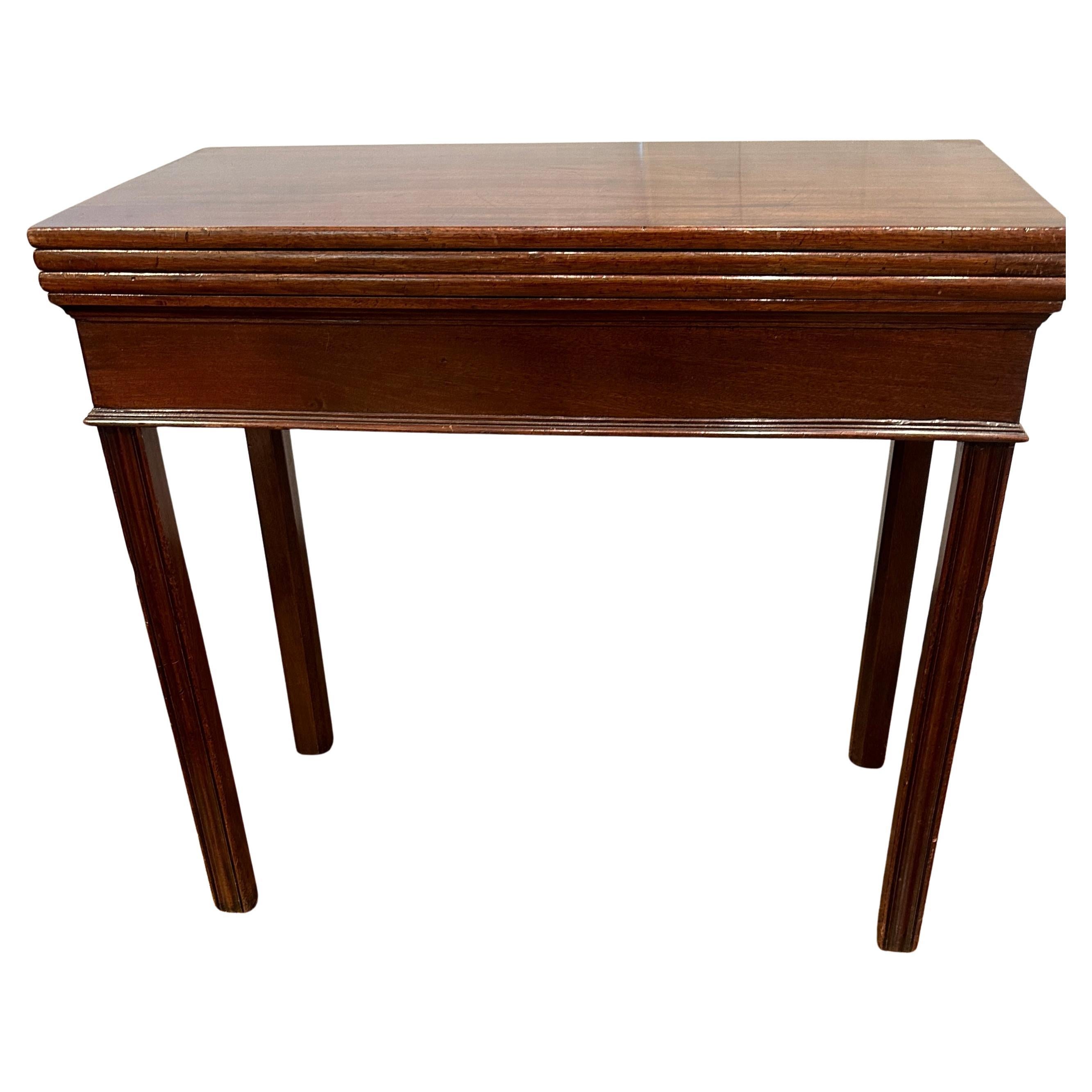 Beautiful 19th Century English folding Game Table with three surfaces tops.  First top  surface is inlaid for chess or backgammon game,  2nd surface is covered in leather for card games.  Third top  is beautiful polished Rosewood surface. 
The 