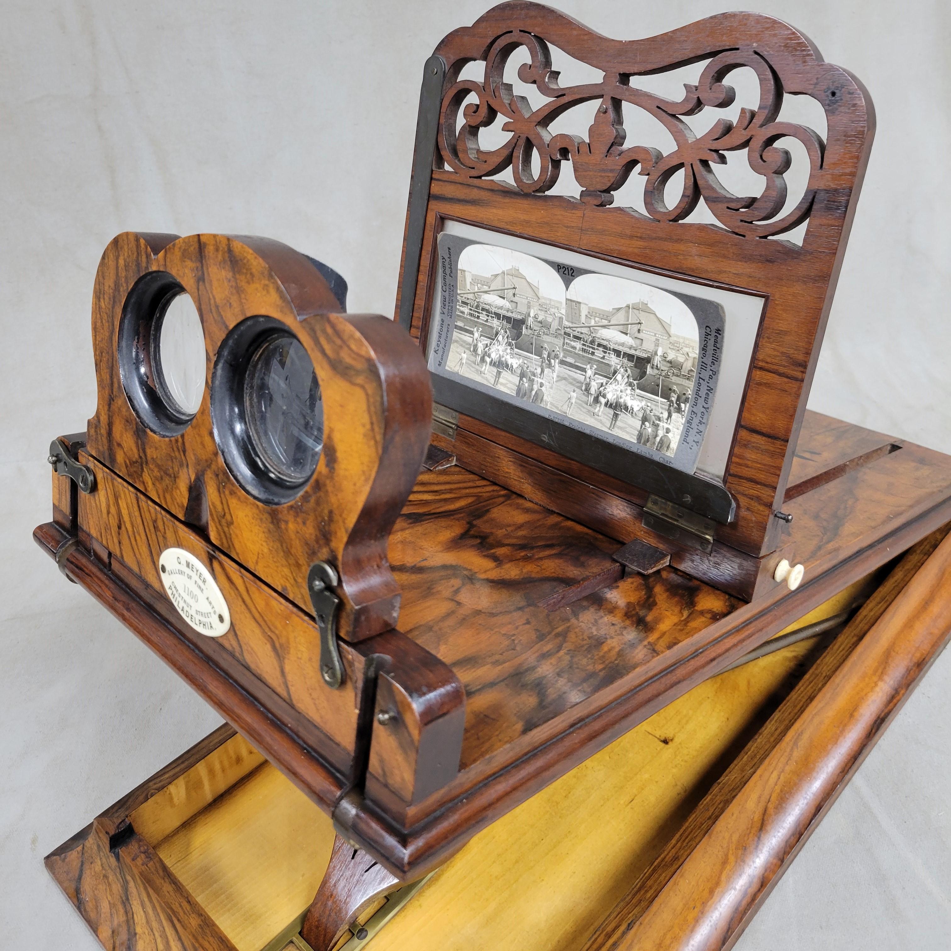 This stunning and highly unusual folding stereoscope viewer was crafted out of rosewood and brass in the Victorian style of the late 1800s. The plaque attached to the eyepiece is inscribed, 