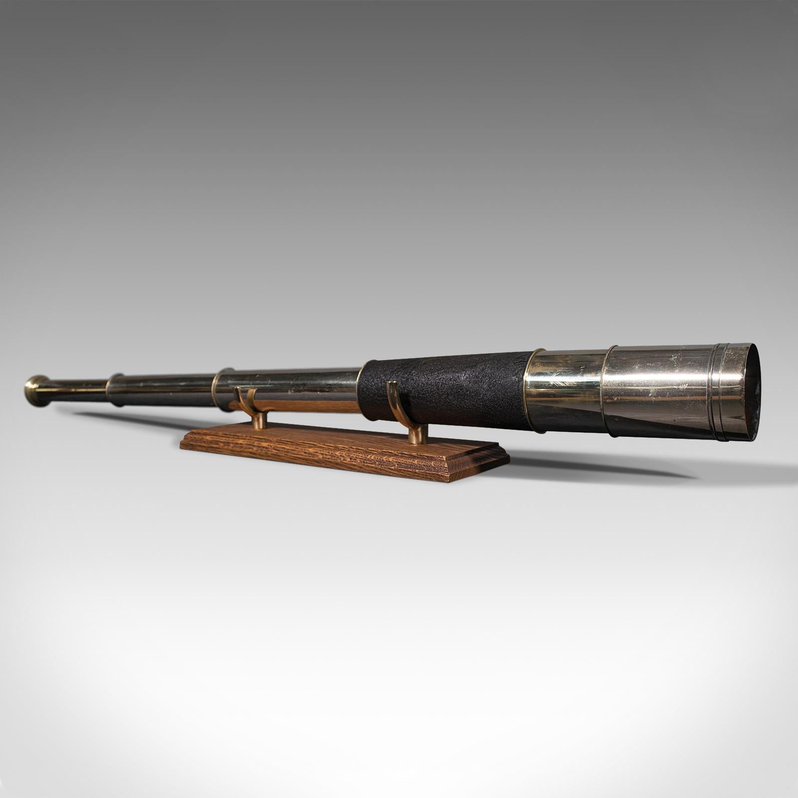 This is an antique Ross of London telescope. An English, brass three draw terrestrial refractor, dating to the early 20th century, circa 1920.

Perfect for bird watching, landscape appreciation, wildlife, or maritime observation. Equally suitable