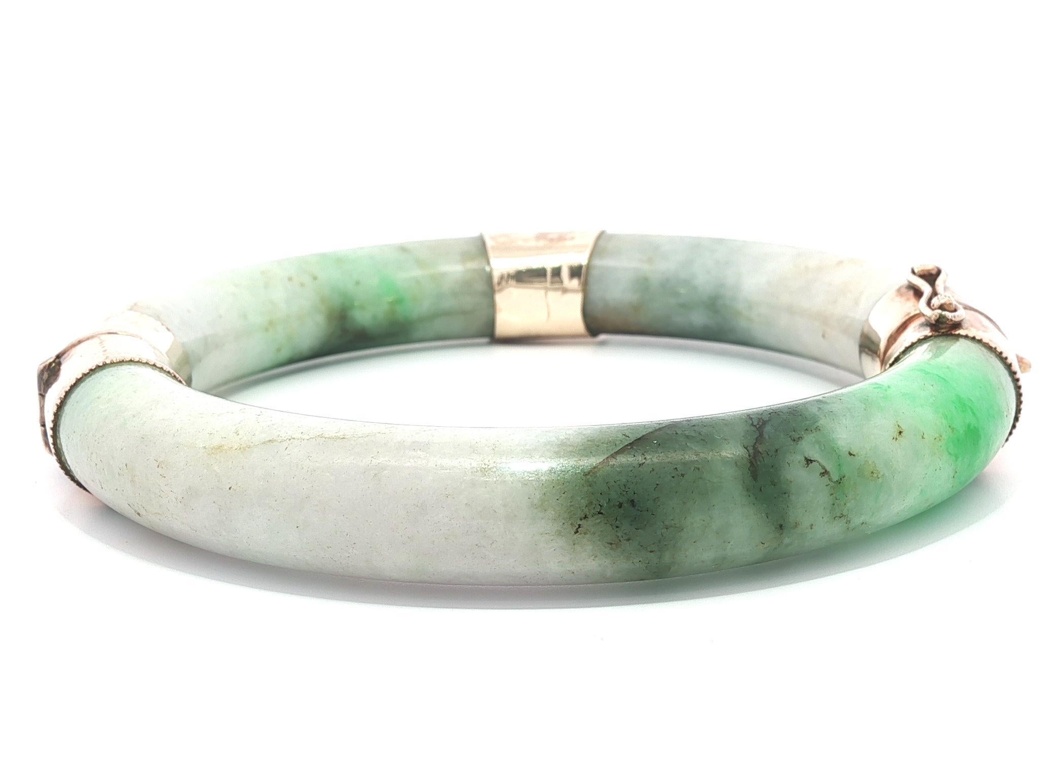 --Pierre(s) :...
(3) Jade véritable naturel - Segment en forme d'arc - Couleur vert fondu - Largeur 10,9 mm (environ)

MATERIAL : Capuchons et fermoir en or jaune rose 10k massif 
Poids : 68,30 grammes
Type de bracelet : Bracelet à