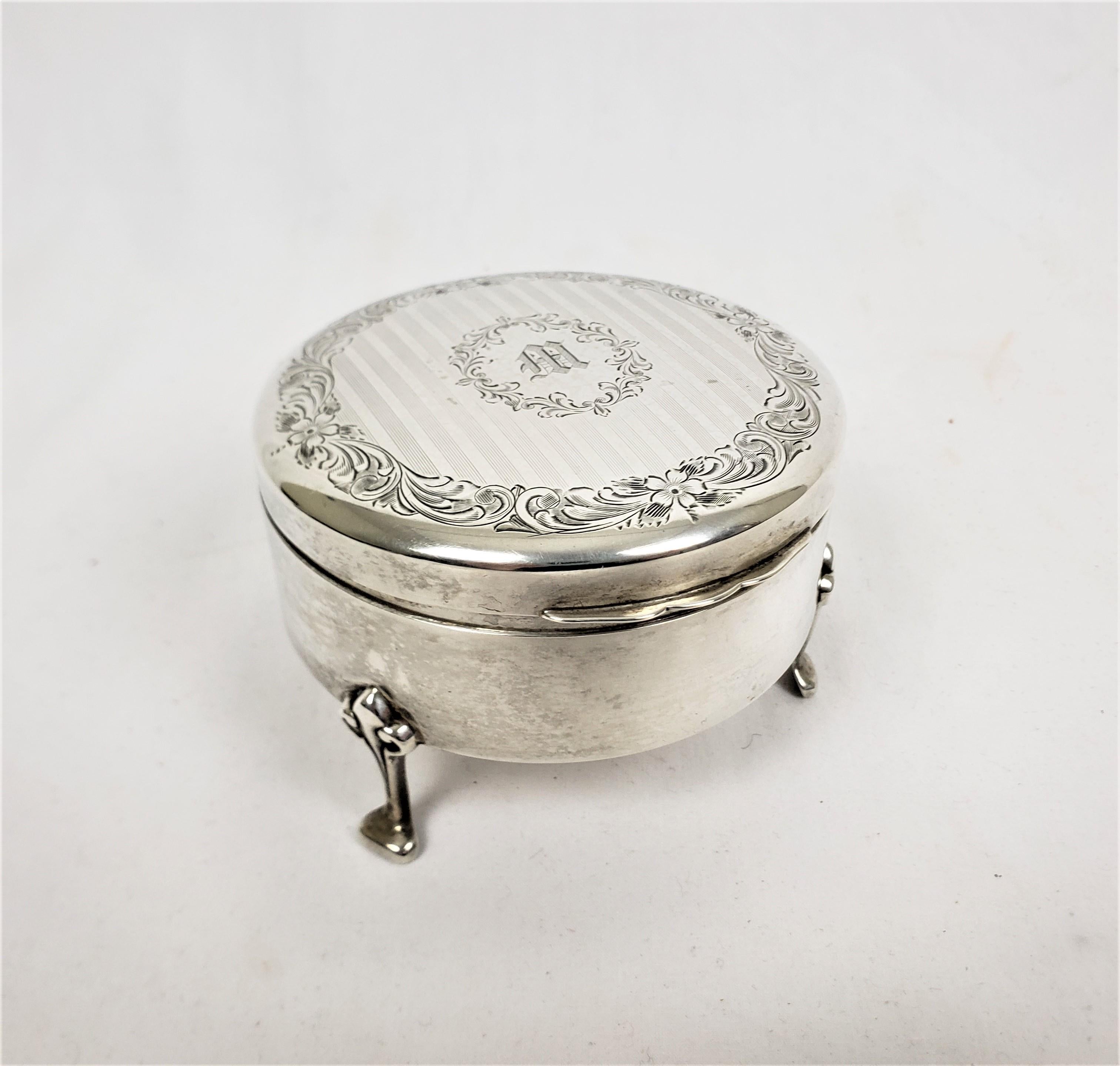 This jewelry and ring or tricket box was made by and unknown English maker and retailed by Birks. The box dates to approximately 1920 and is done in a Victorian style. This ring box is cmposed of sterling silver with a velvet lined interior. The box