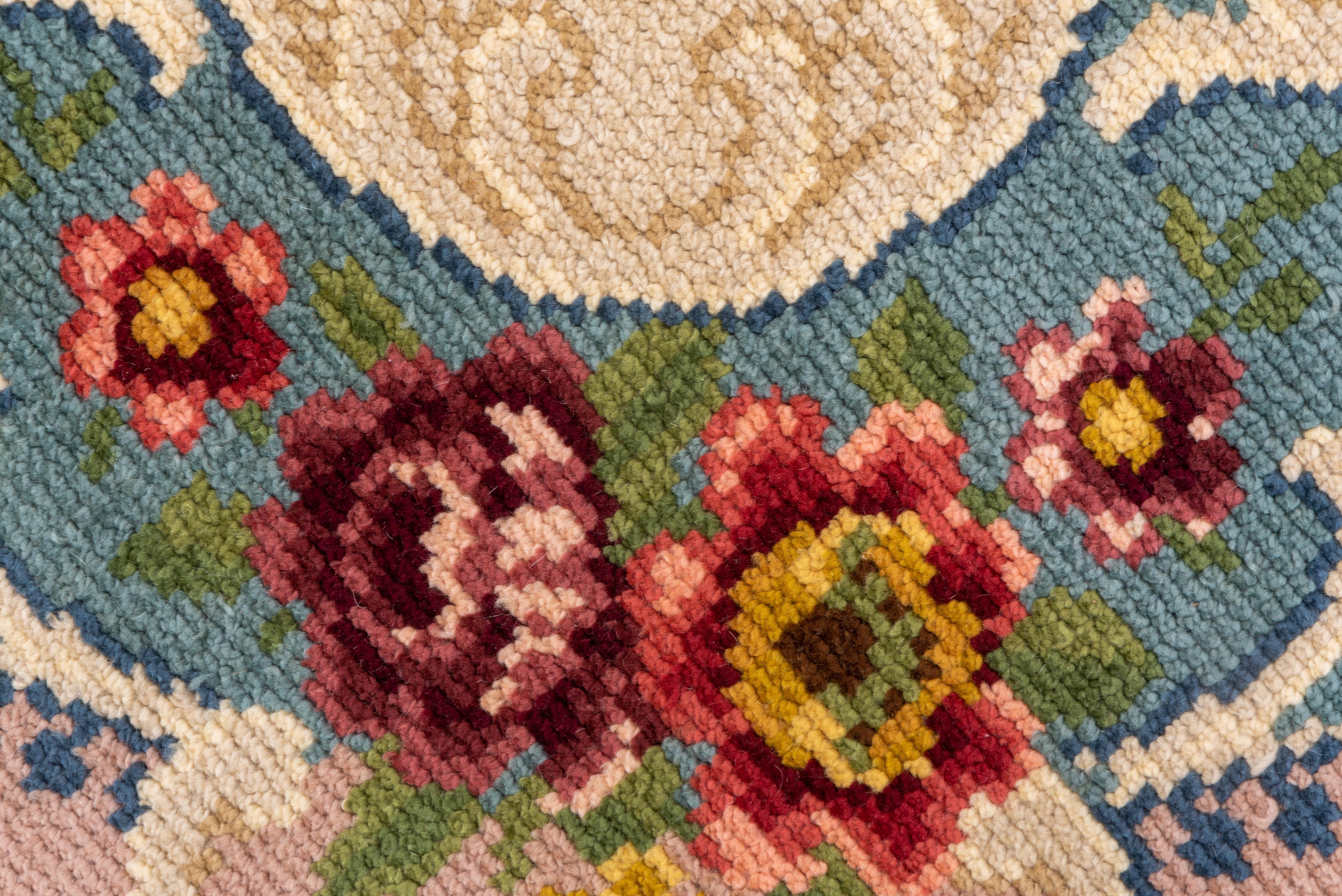 This coarsely knotted piece shows a colorful rose wreath on the sand ground. Additional roses decorate the teal inner border. Detail tones include lemon, goldenrod,off white, red, medium blue, black and pale celadon.