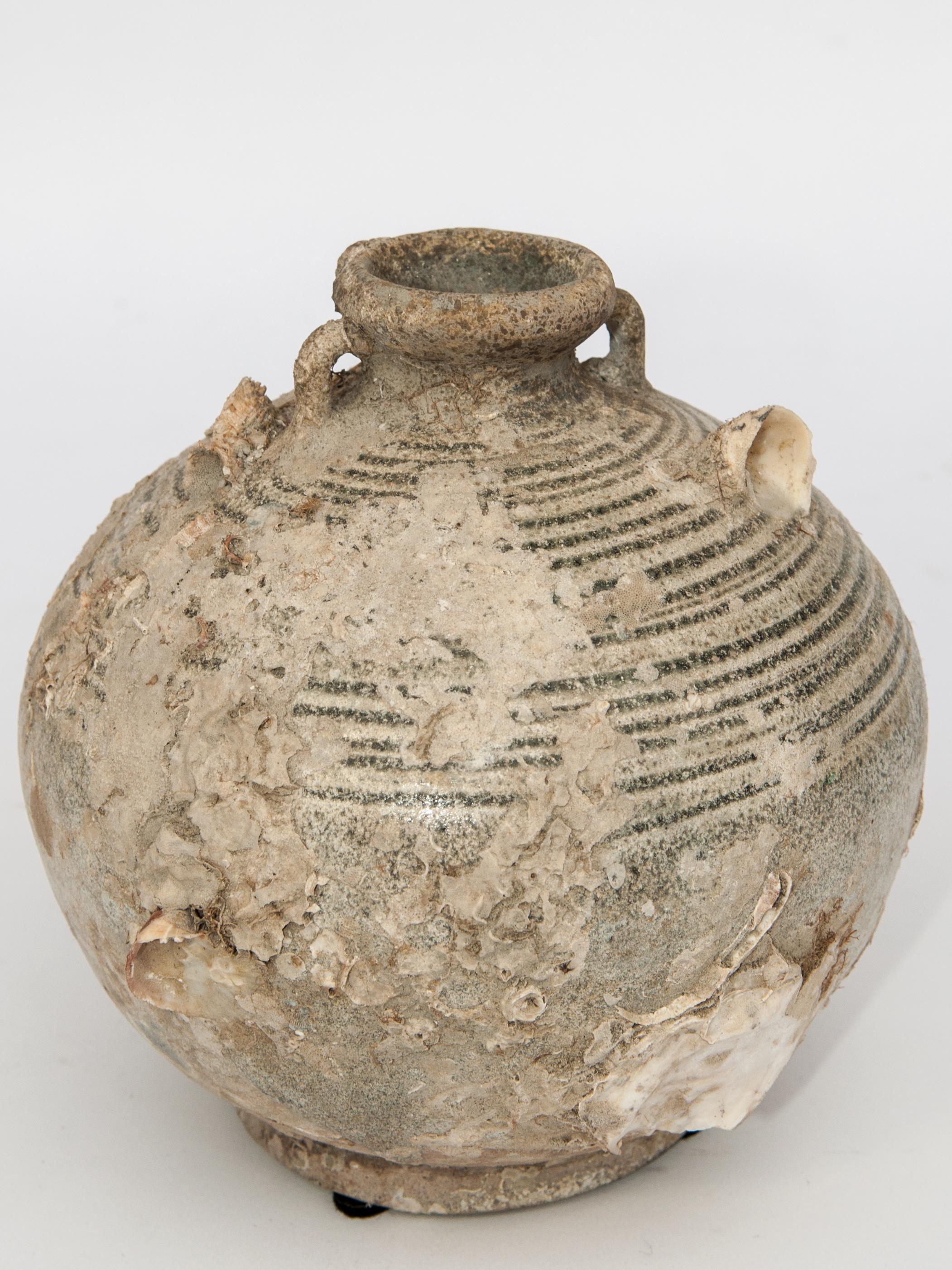 Antique Round Sawankhalok Jar with Encrustations. 6 inches tall. Sawankhalok, Thailand, 15th century.
This jar originates from the kilns of central Thailand centered around the area of Si Sachanalai dating to the Sukhothai period. Sawankhalok