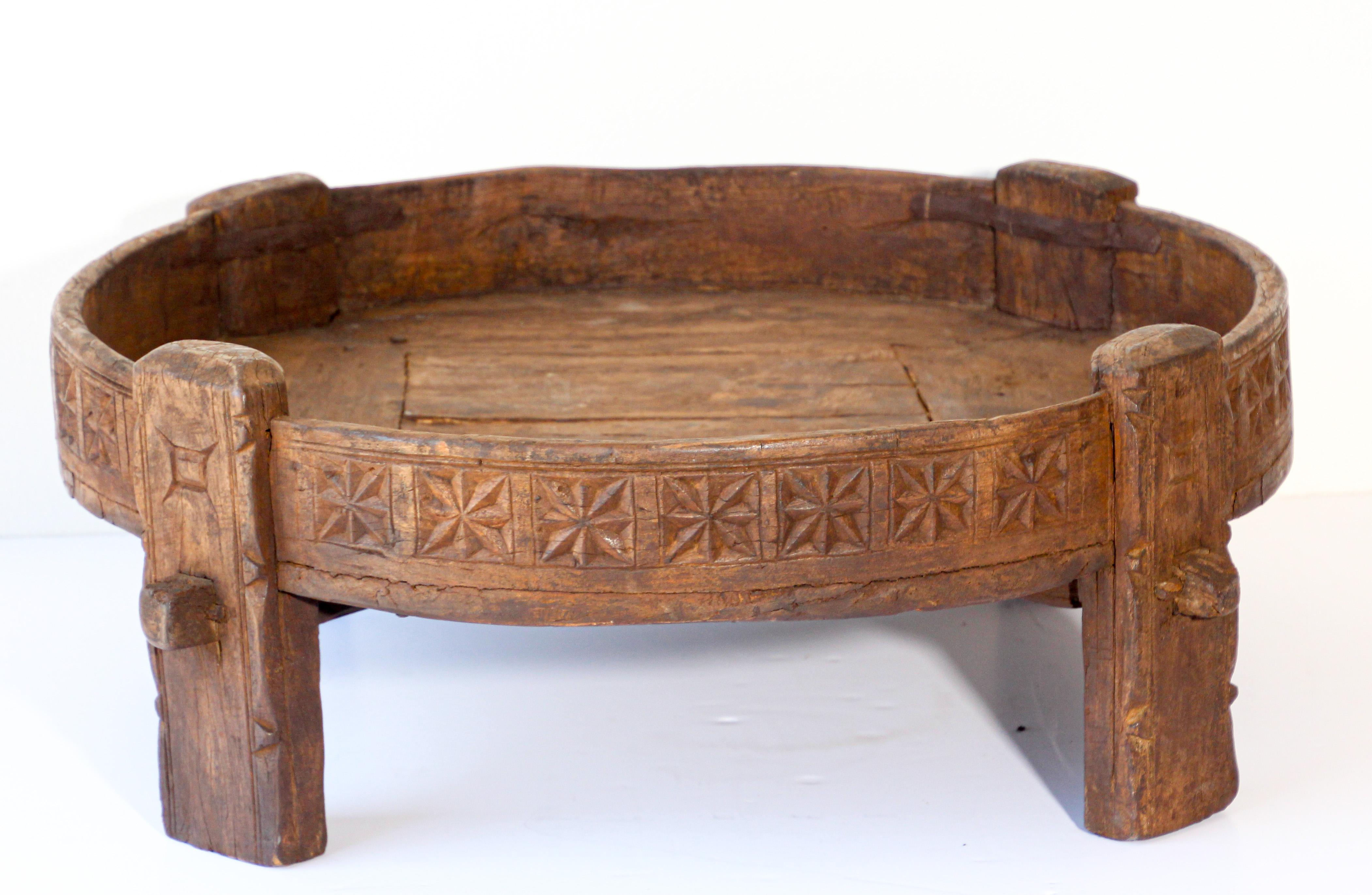 Large antique hand carved wood Indian grinder tribal table.
Walnut color hand carved with geometric tribal design.
Handcrafted of wood and iron, hand carved with geometric Ethnic tribal design.
Very sturdy rustic wood table with nice patina,