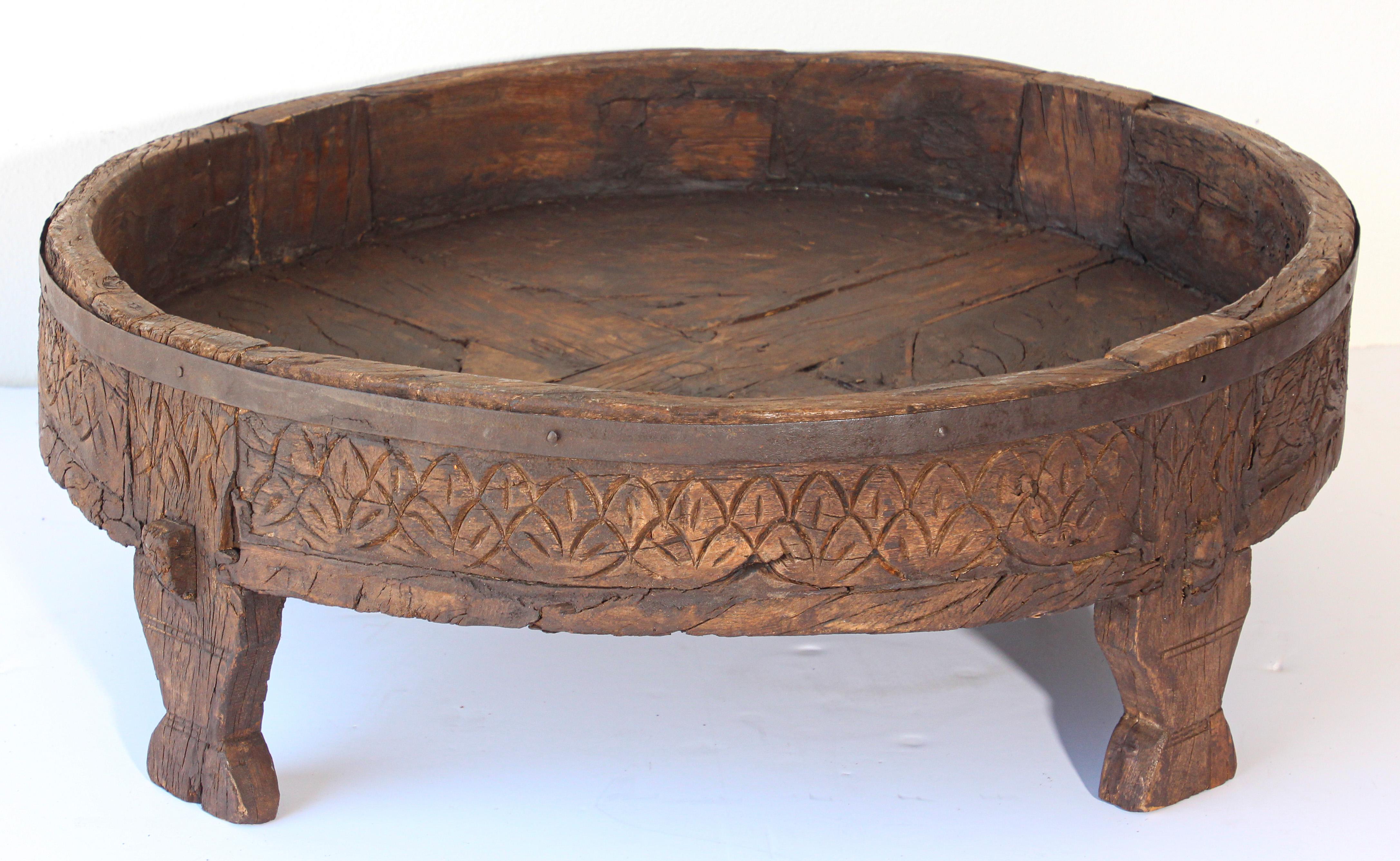 Large antique hand carved wood Indian grinder tribal teak table.
Walnut color hand carved with geometric tribal design.
Handcrafted of wood and iron, hand carved with geometric Ethnic tribal design.
Very sturdy rustic wood table with nice patina,