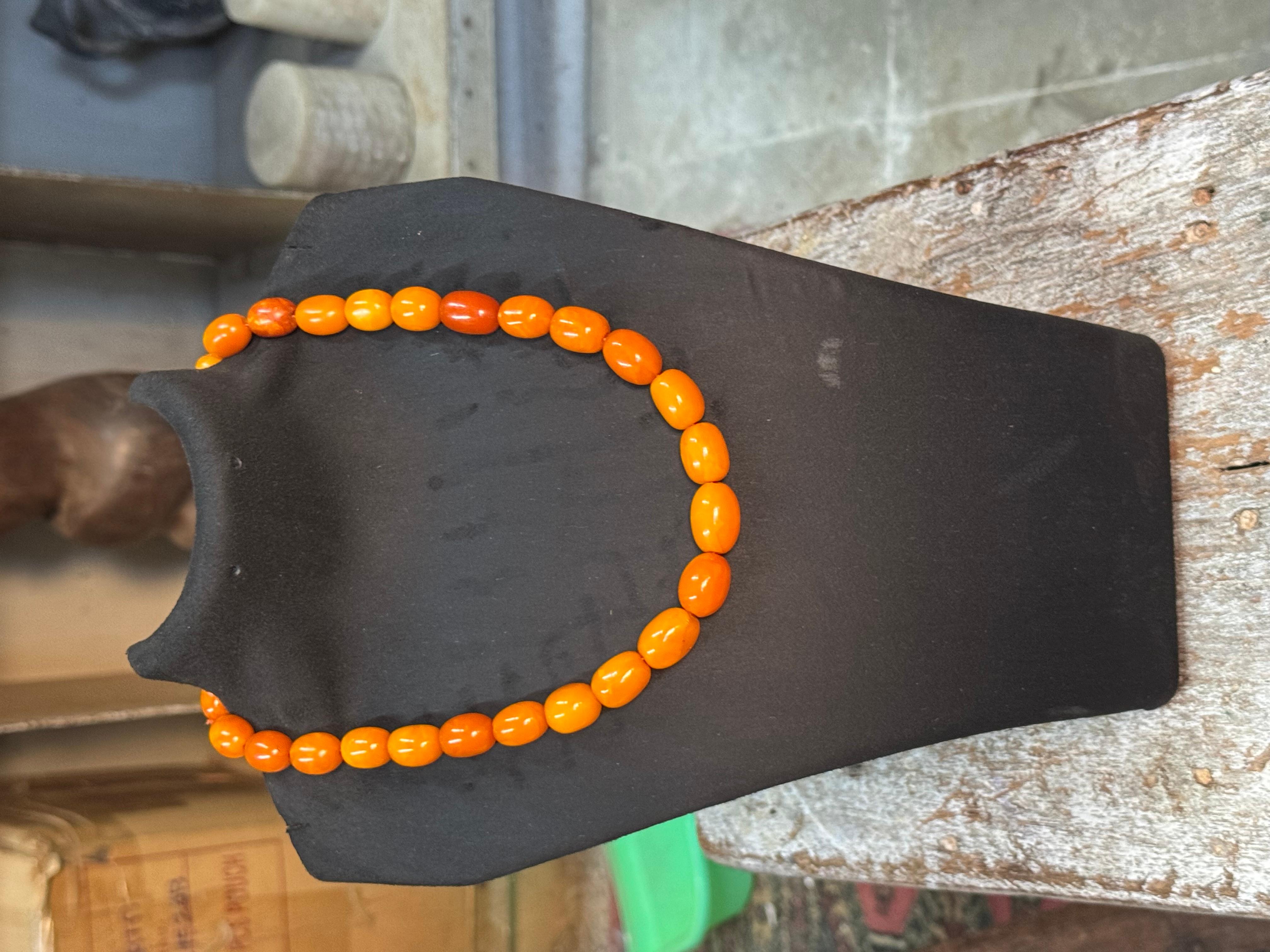 Diese antike Bernsteinperlen-Halskette besteht aus einer Reihe von gelben Bernsteinperlen in Kissenform. Die Kette ist mit einem Verschluss aus 9 Karat Roségold verziert und wiegt insgesamt 37 g. Das Stück ist von hoher Qualität und stammt aus der