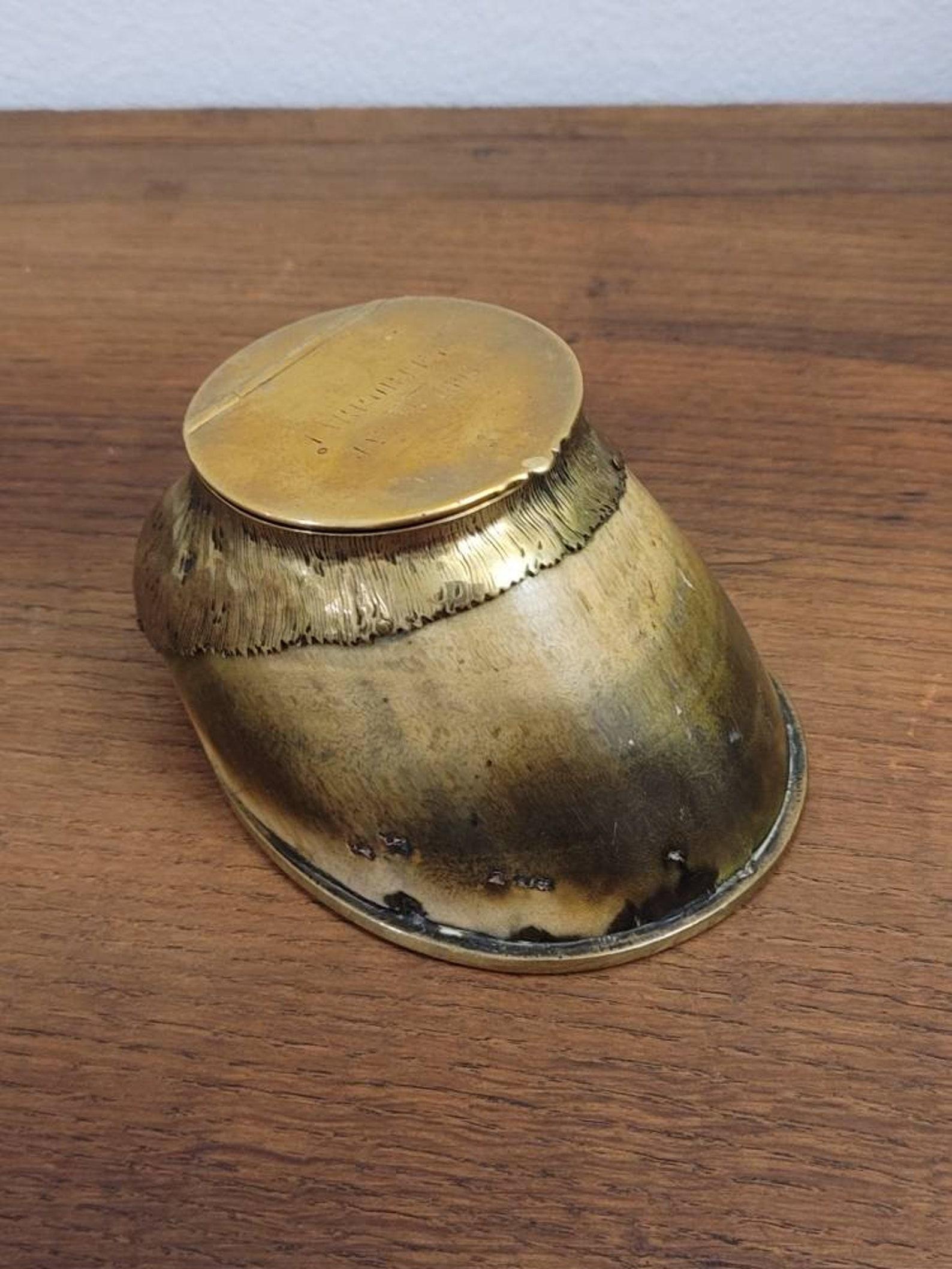 A rare and important late 19th century Victorian era metal mounted horse hoof match holder by Rowland Ward.

Museum quality example, this most unusual curiosity having a gilt brass hinged lid opening to striker and open receptacle. Signed 