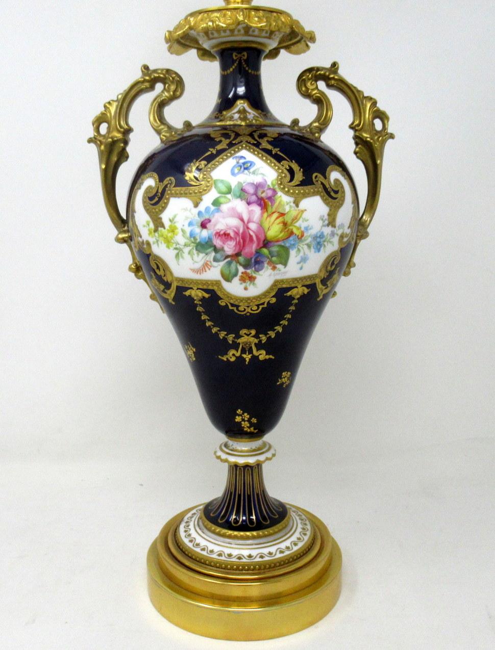 Stunning English Porcelain Royal Crown Derby twin handle hand decorated vase of ovoid outline and generous proportions, now converted to an Electric Table Lamp, painted by Albert Gregory, circa 1900.

The delicate twin handles, neck and foot with