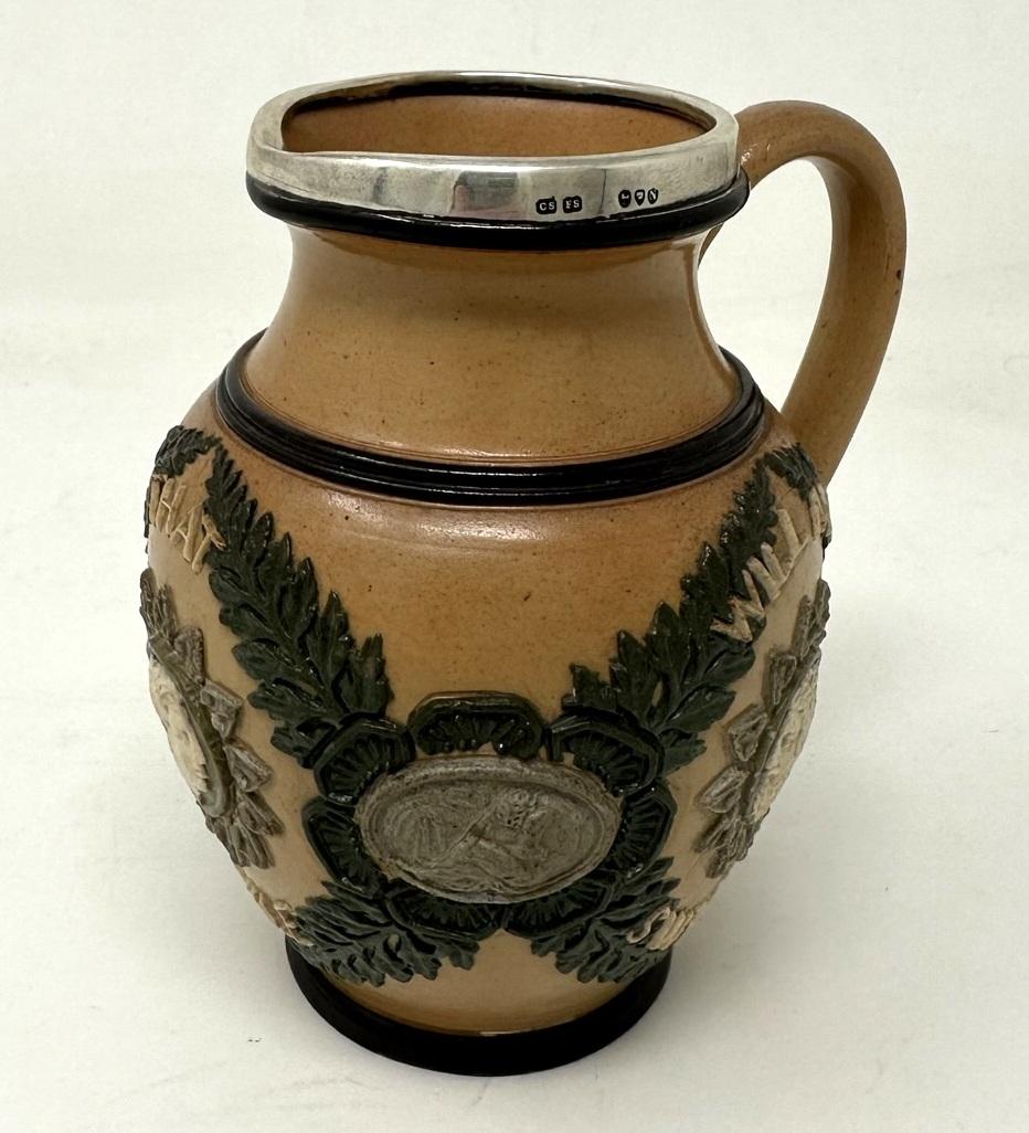 A Rare Example of a Royal Doulton Lambert Earthenware or Stoneware Silver Rimmed Cream Jug made during the last quarter of the Nineteenth Century.  

The main body exquisitely applied with cameos and intaglios depicting male figures on Acanthus leaf