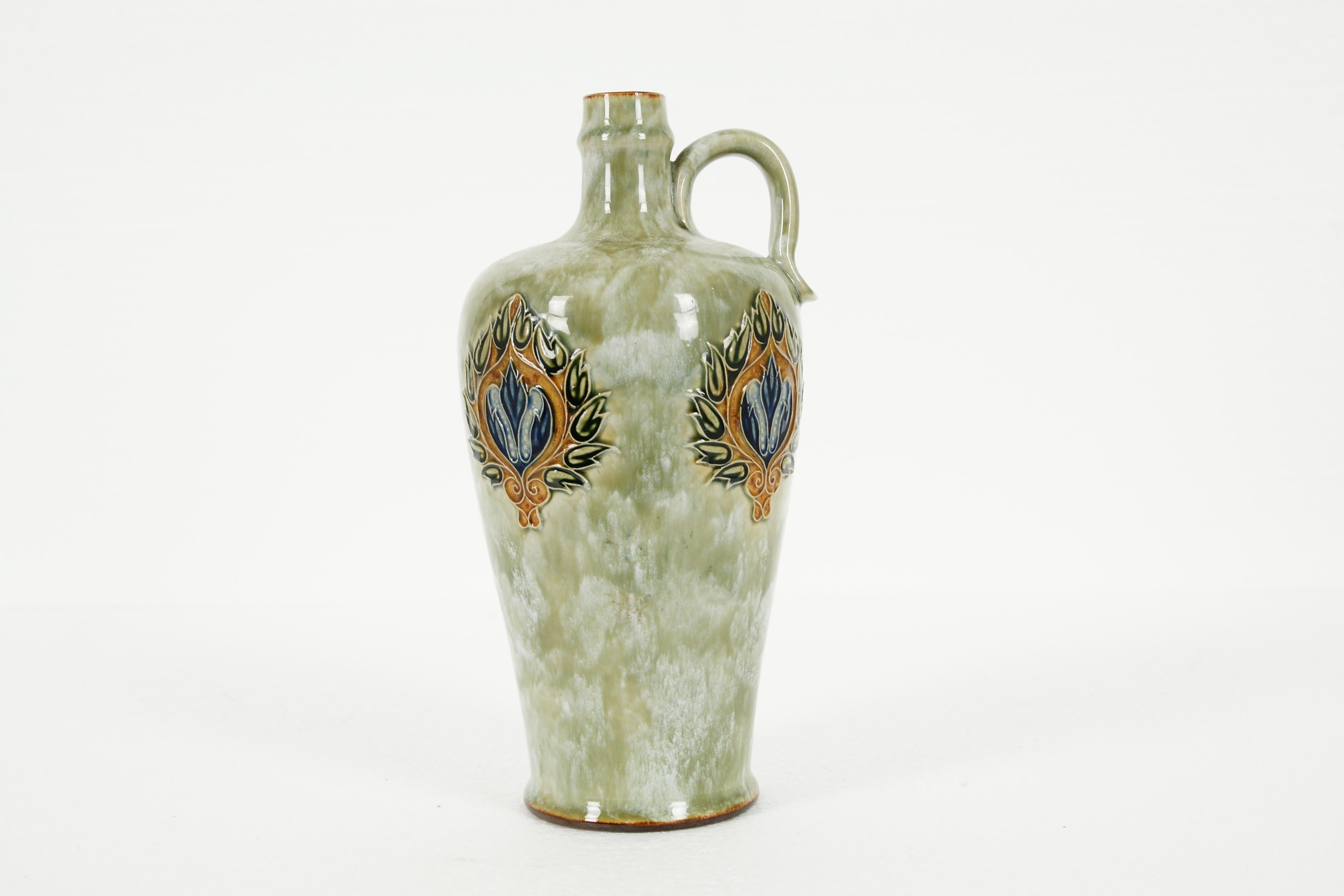 Antique Royal Doulton, whisky bottle, BB7, B143 SKU B1972

Inverse baluster with mottle green glaze
Decorated with Art Nouveau floral design
Timed ridging at the foot
Impressed factory marks
Missing stopper
Excellent condition
BB7,