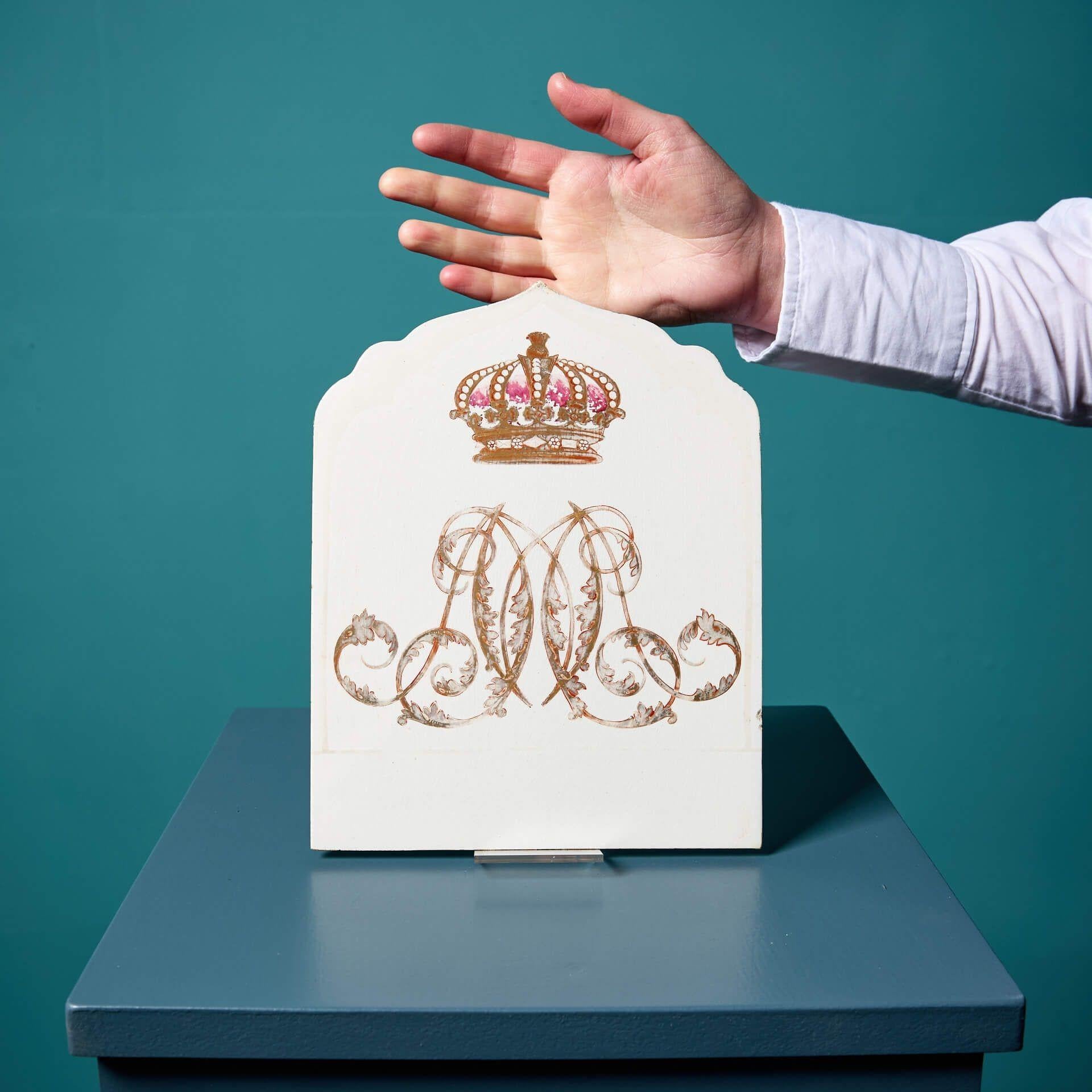 An antique glazed tile with an elaborate interlaced monogram below a gilded crown, circa 1880, in the manner of Copeland. With its unusually shaped design and large scale, this Victorian tile was likely a one-off commission, making it a rare 19th