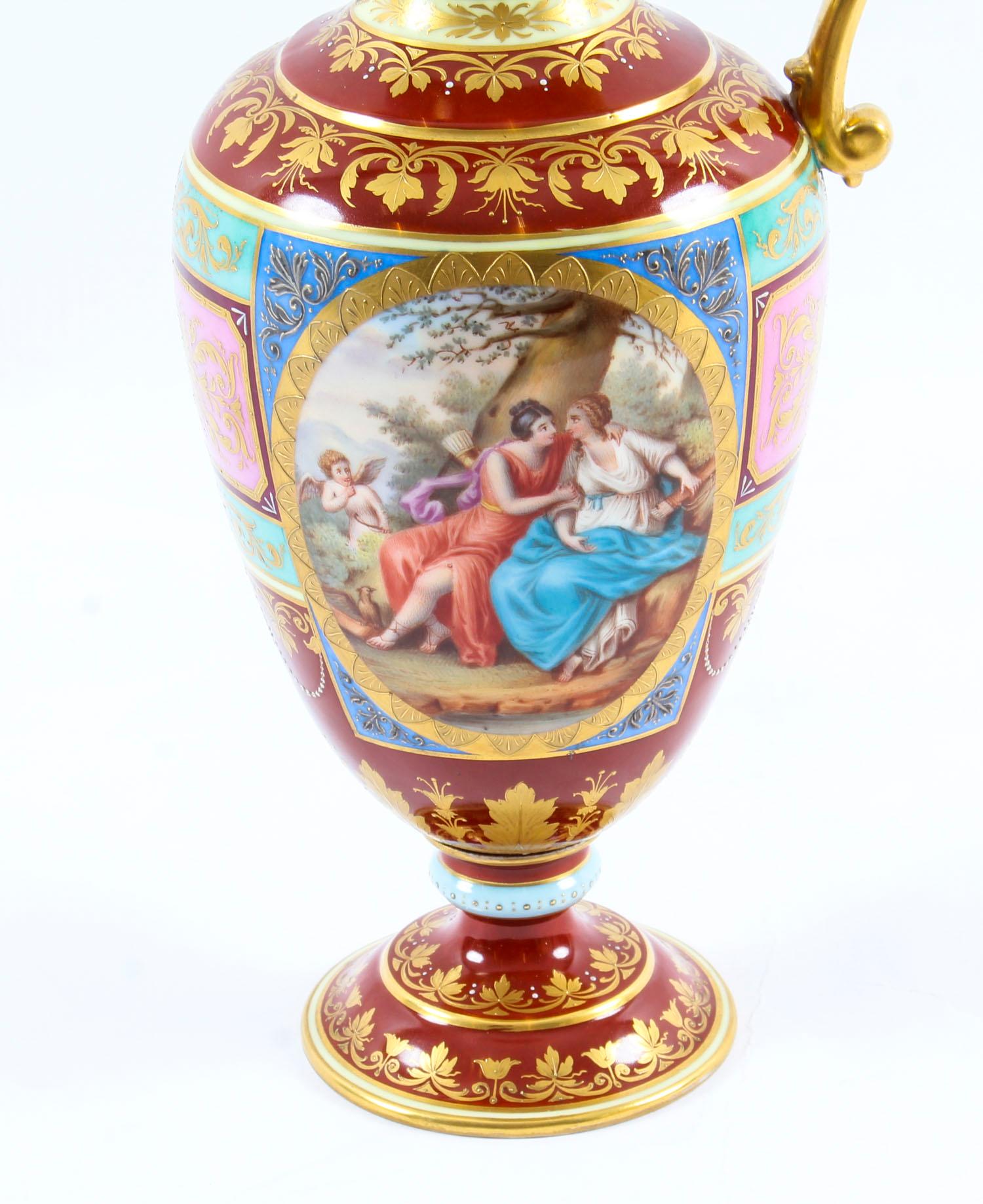 This is a stunning and rare antique Royal Vienna Porcelain ewer, dating from the late 19th century.
 
Of baluster form with loop handle and beautifully painted with classical figures in landscape panels on a multi-colored paneled ground